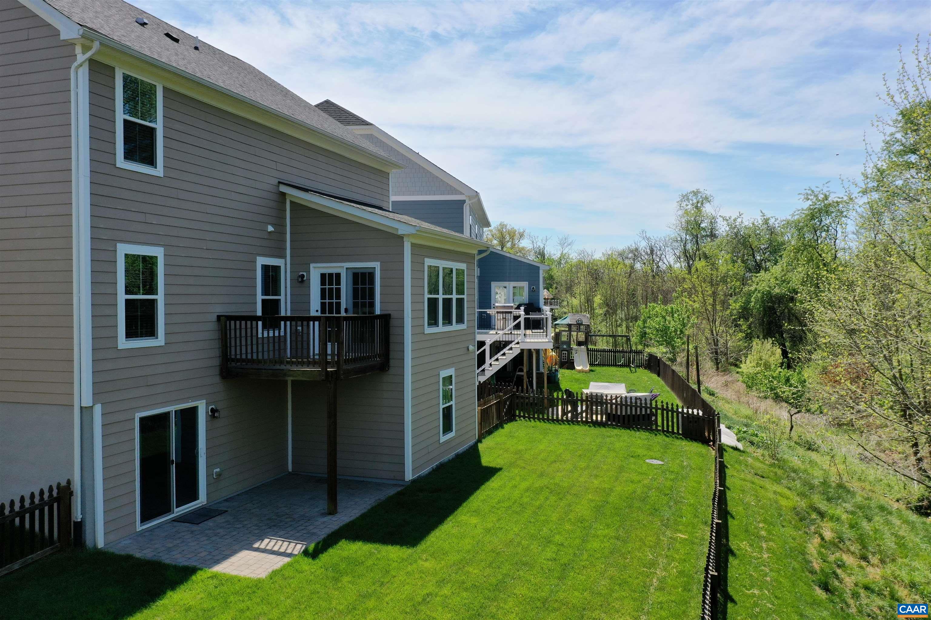 Fenced back yard backs to HOA wooded common space.