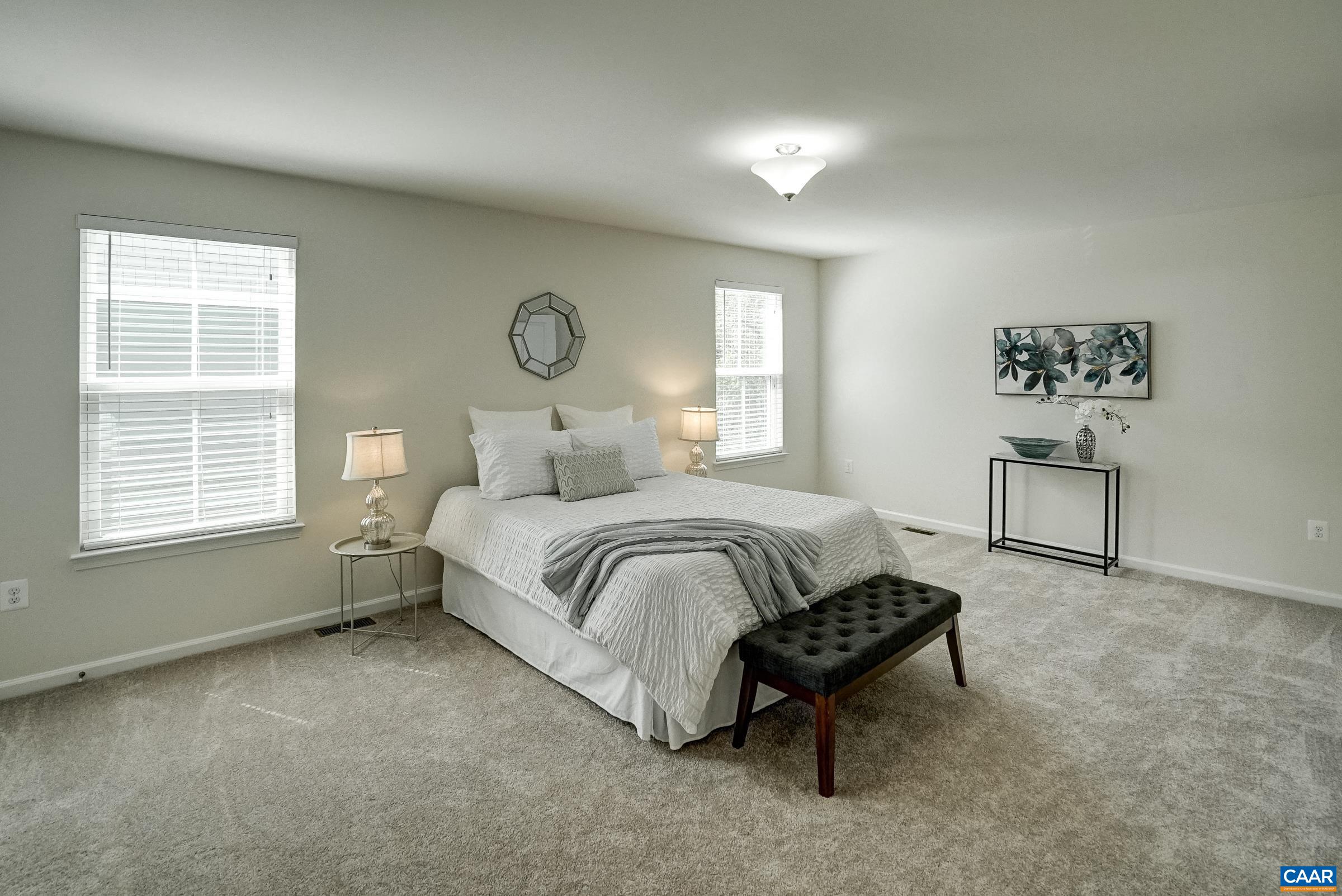 Second floor primary suite features a large walk-in closet and ensuite bathroom.