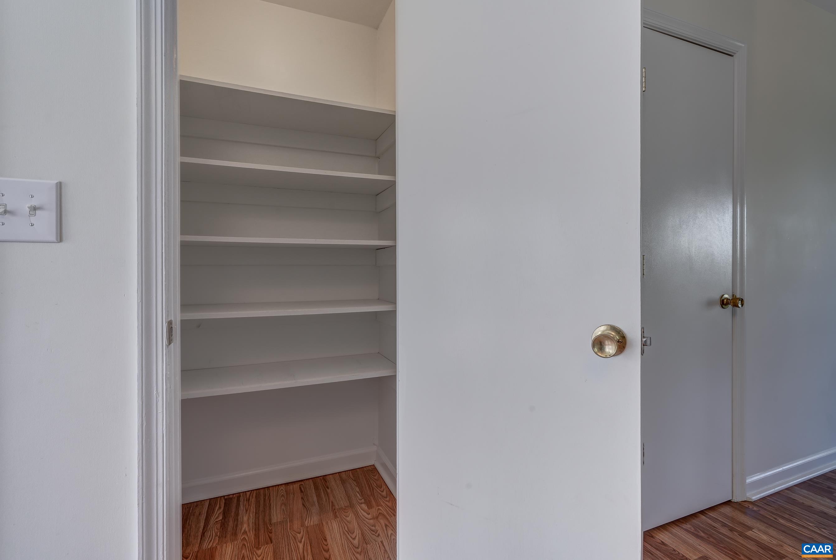 Large pantry with solid shelves.