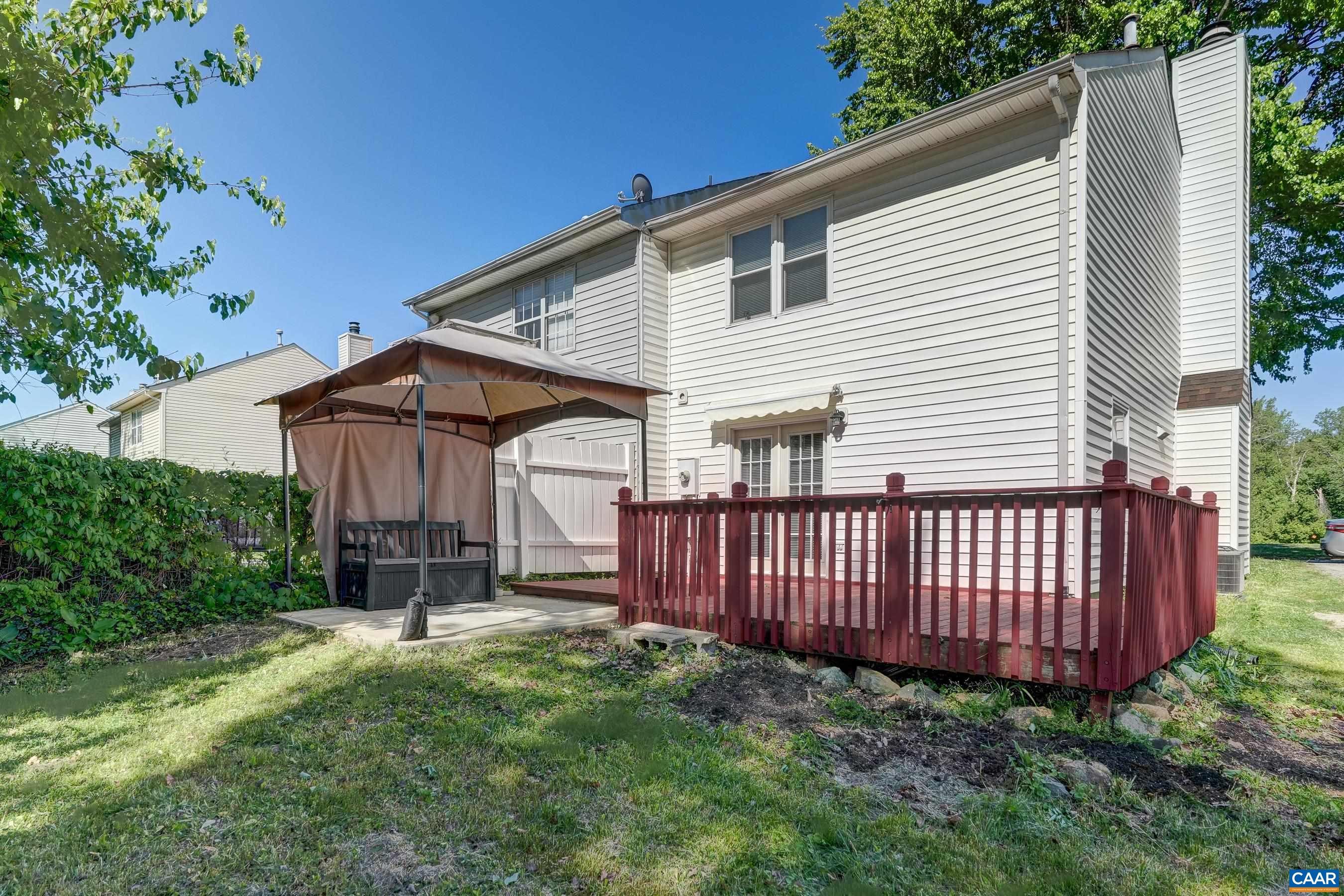 Great back yard with multiple outdoor entertaining areas including a deck with retractable awning and patio with canopy!