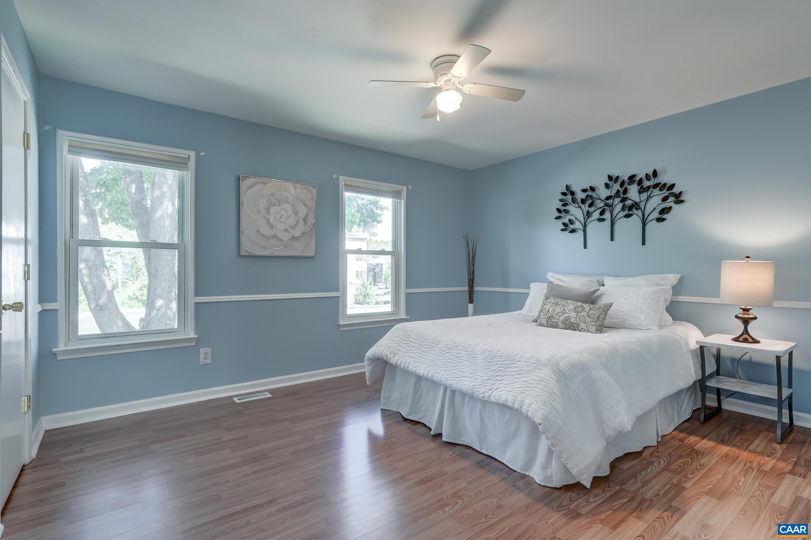 Primary bedroom with walk-in closet and lvp flooring.