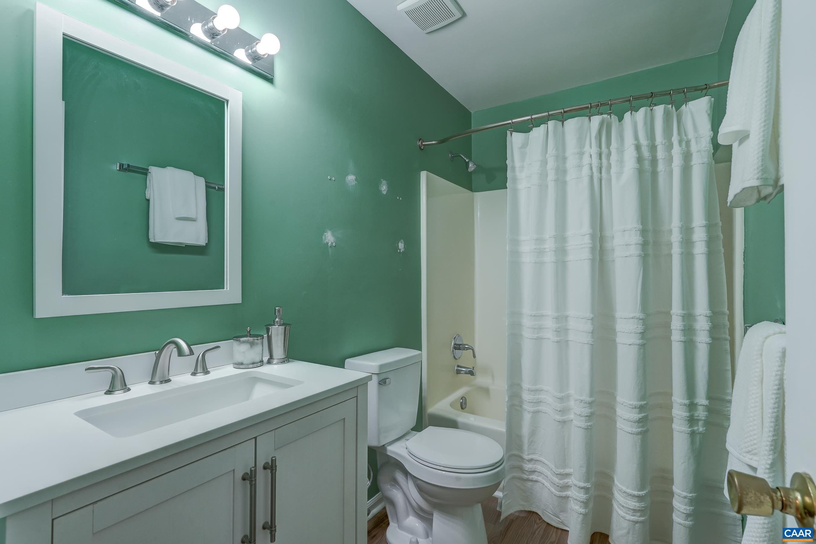 Full hall bathroom with updated vanity and toilet