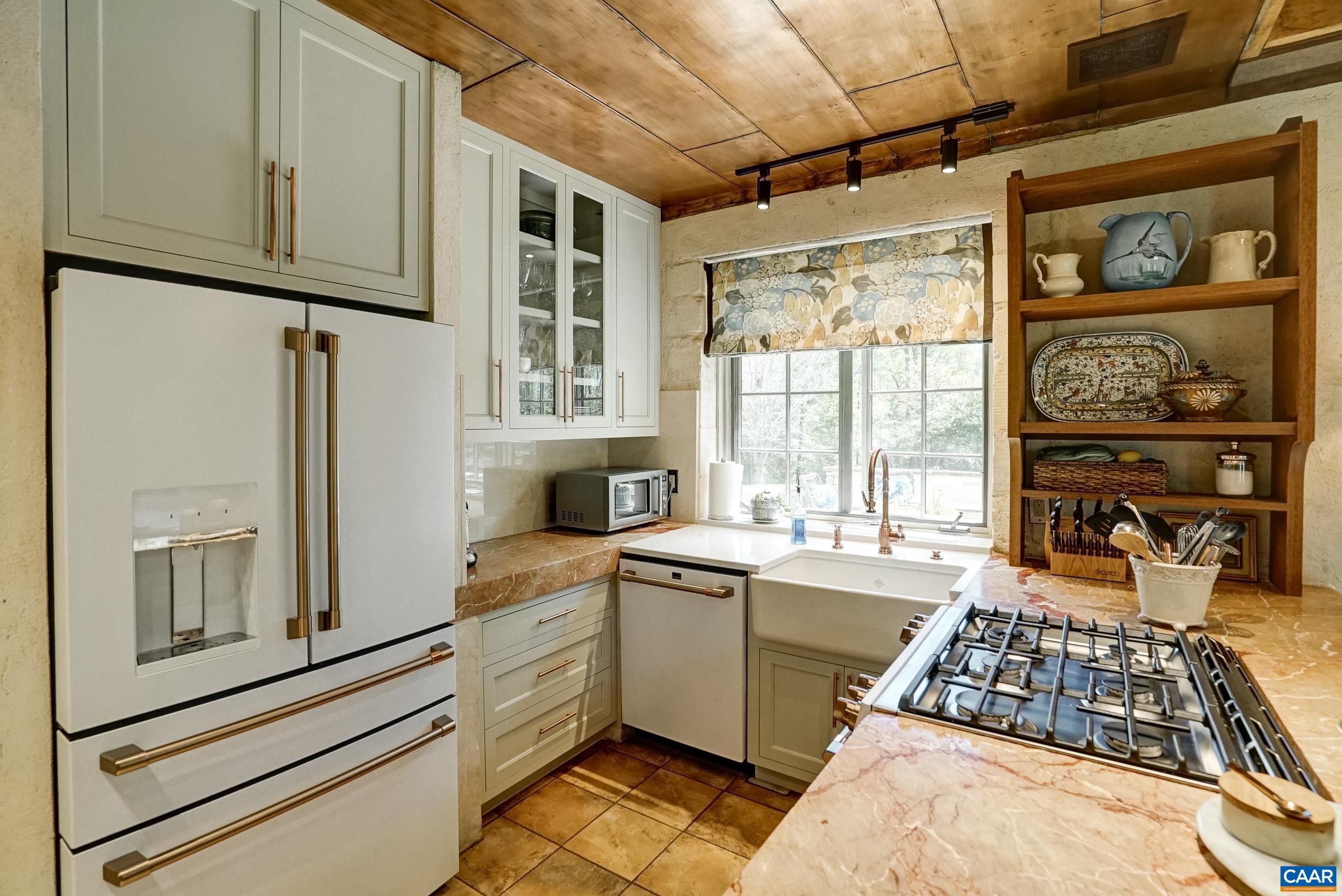 GE cafe matte white appliances including a six burner gas cooktop with convection oven.