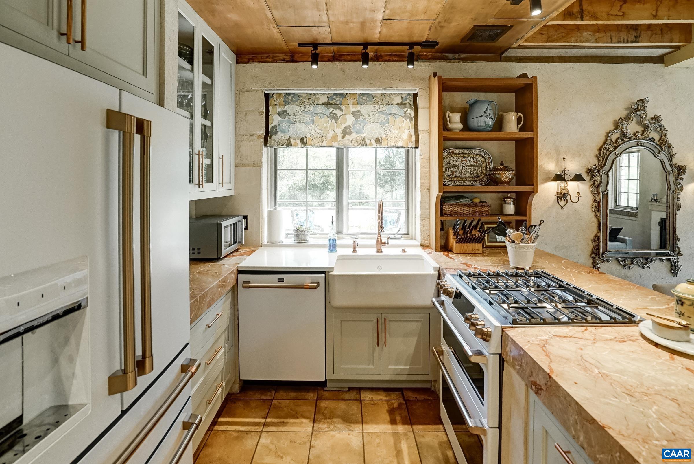 Farmhouse sink with copper faucet.