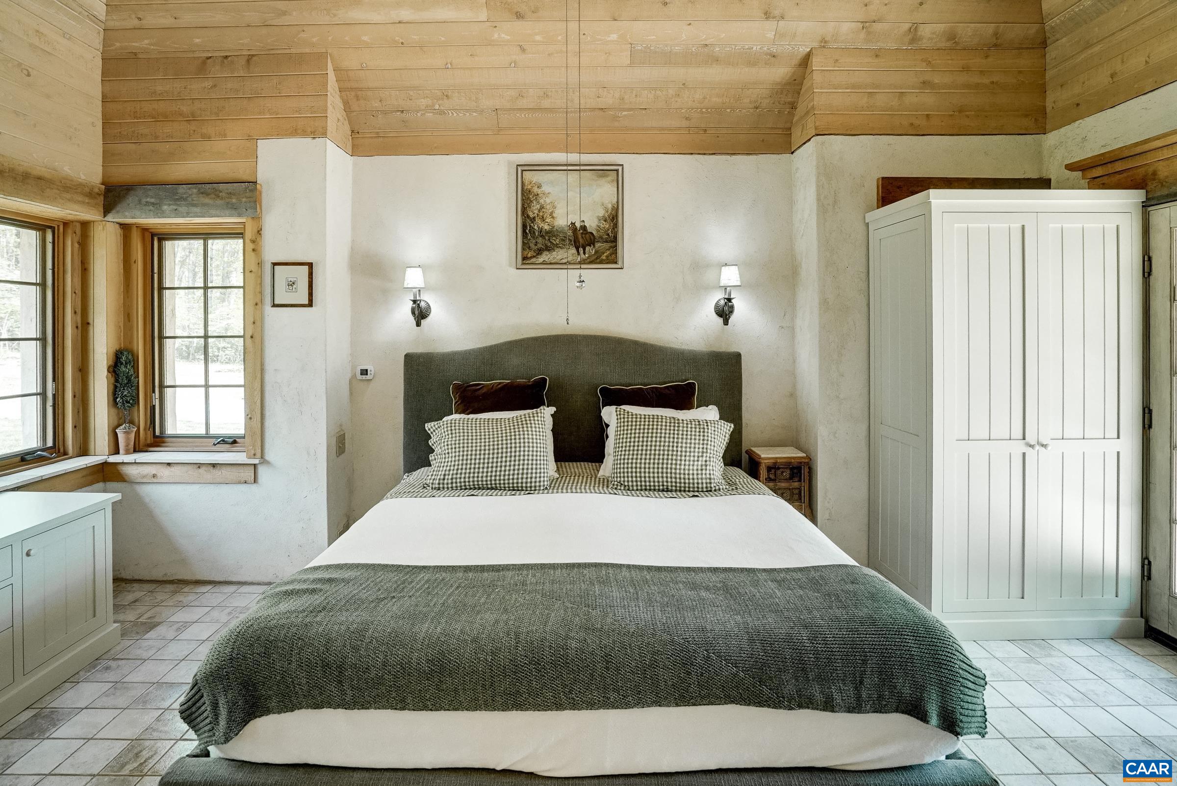 Primary suite features a vaulted bedroom with exposed beams.