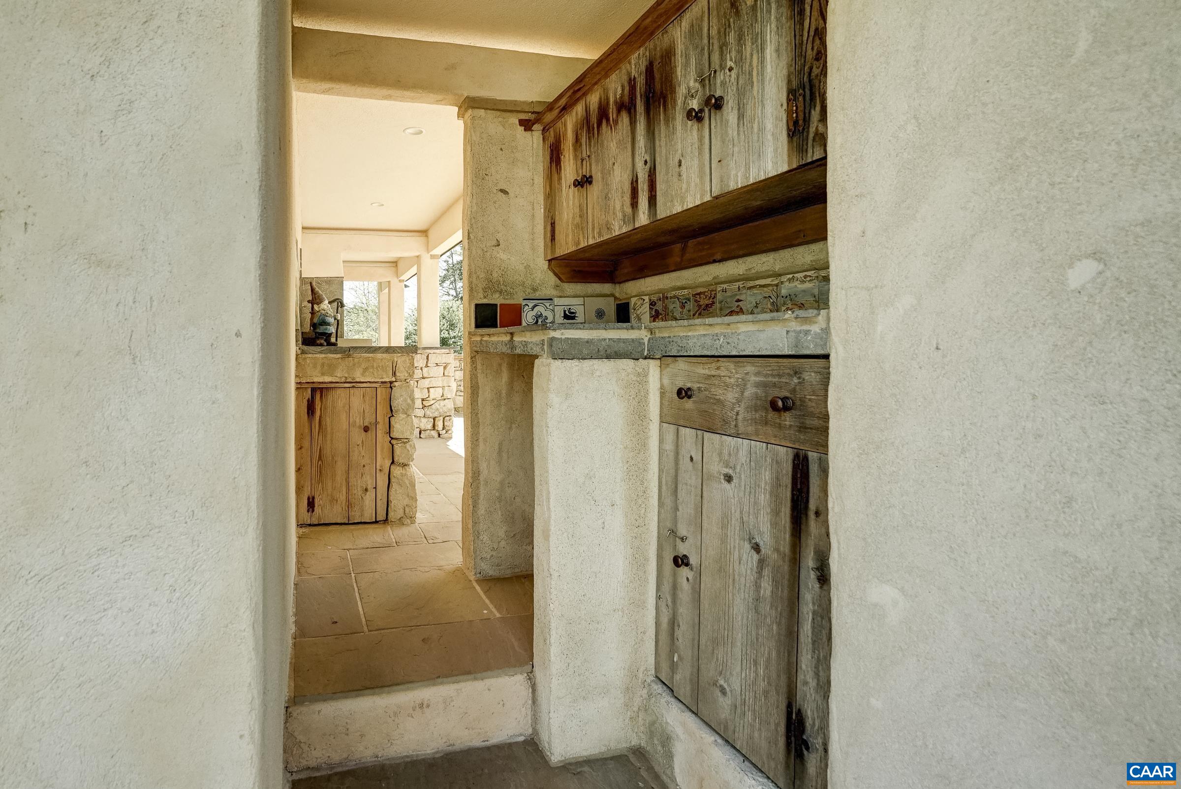 Storage area outdoors with space for a mini fridge.