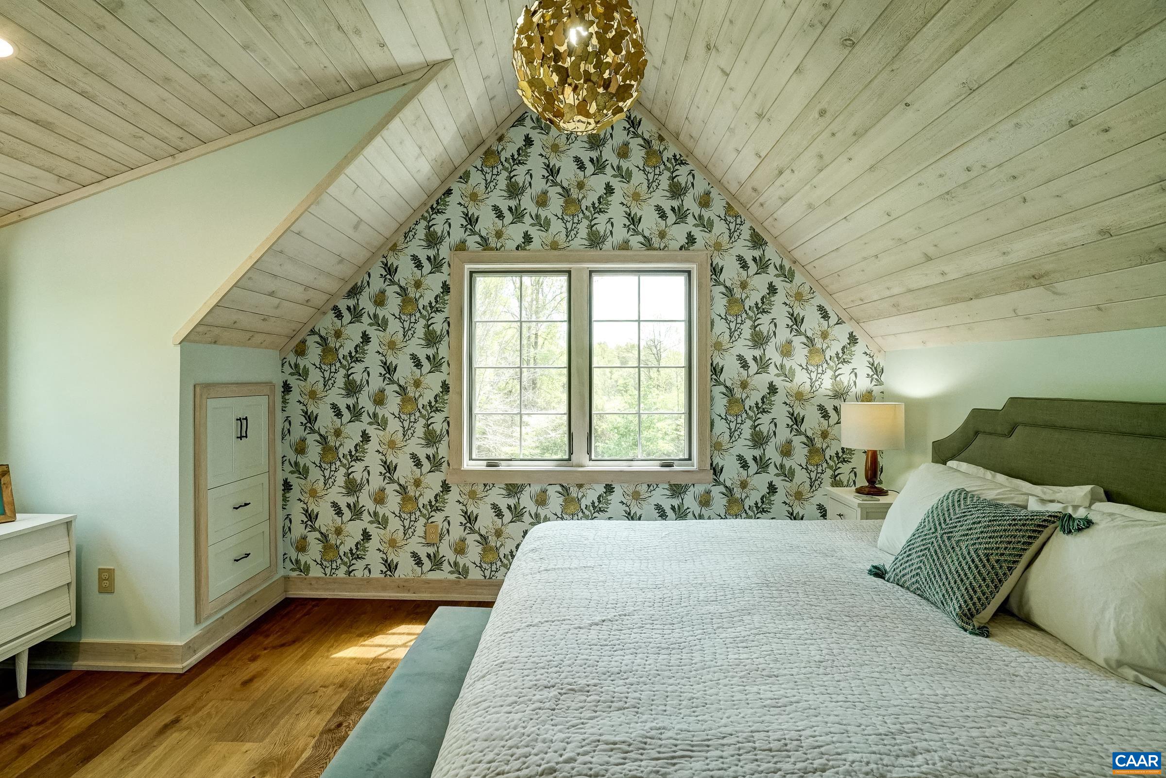 Bedroom 2 features custom built-ins and beautiful wall covering.