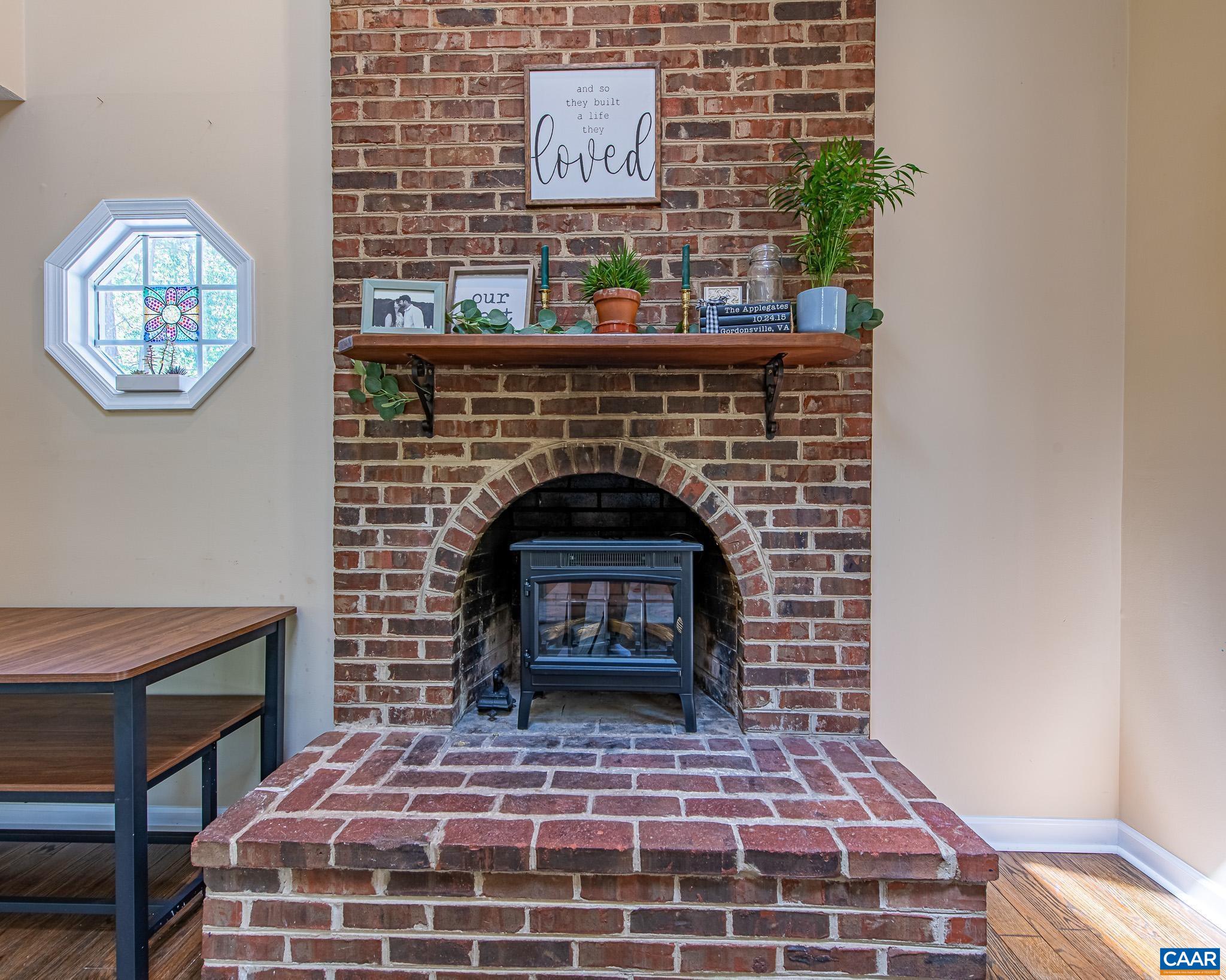 Brick Fireplace - Chimney has been sealed off by current owner & electrical fp insert put in.