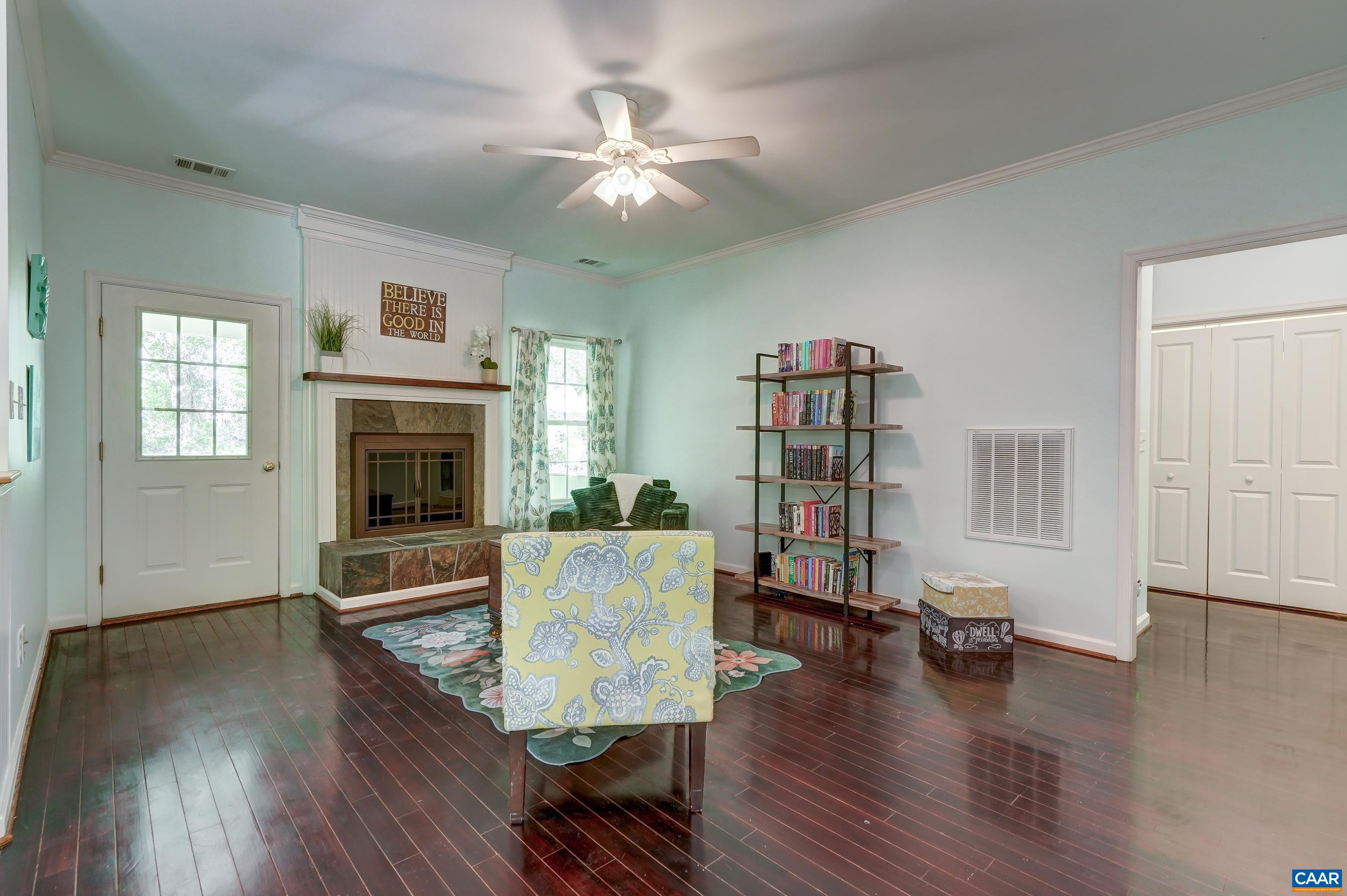 Great room features wood burning fireplace with tile hearth and surround.