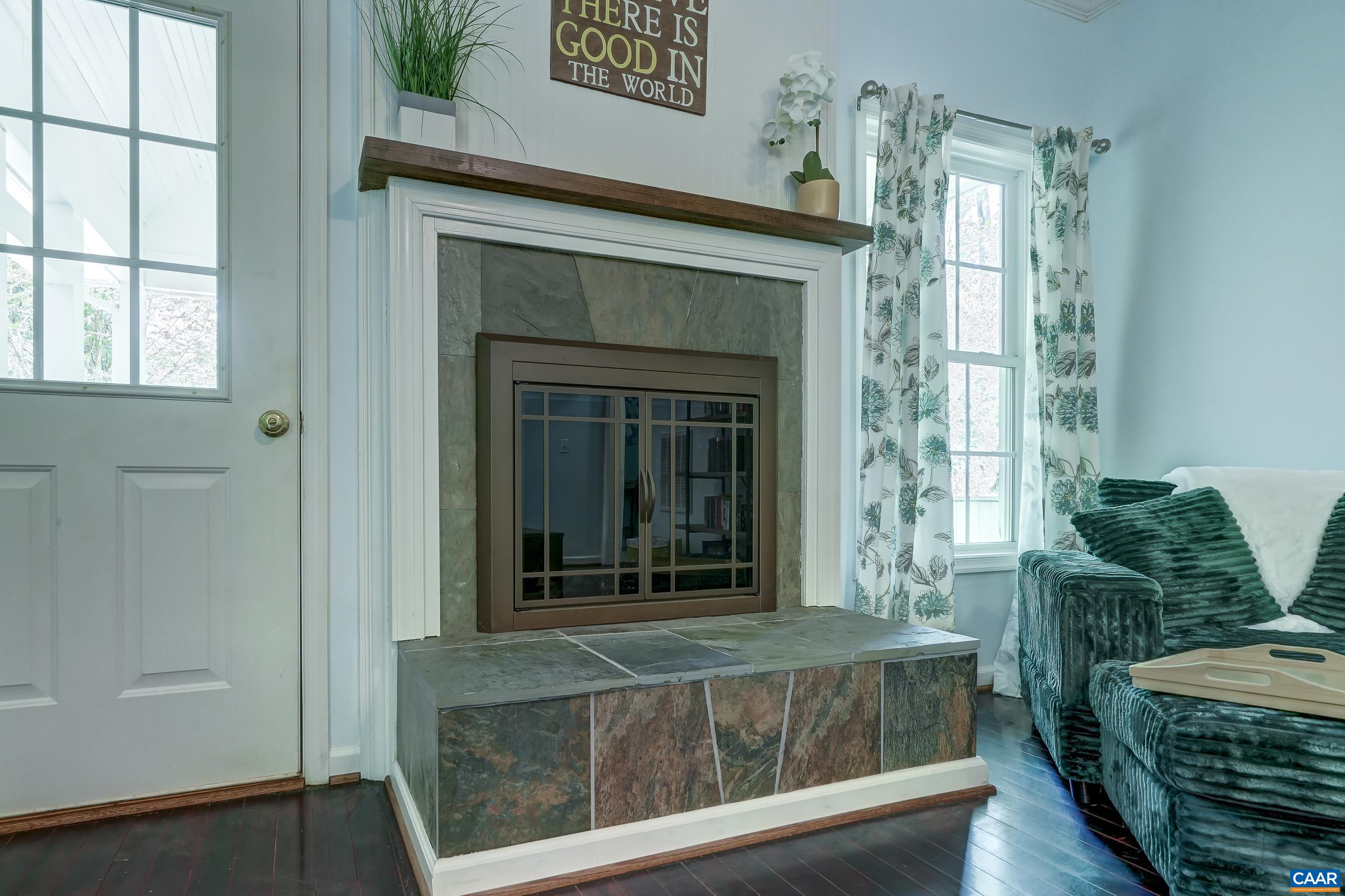 Beautiful fireplace with stained wood mantle.