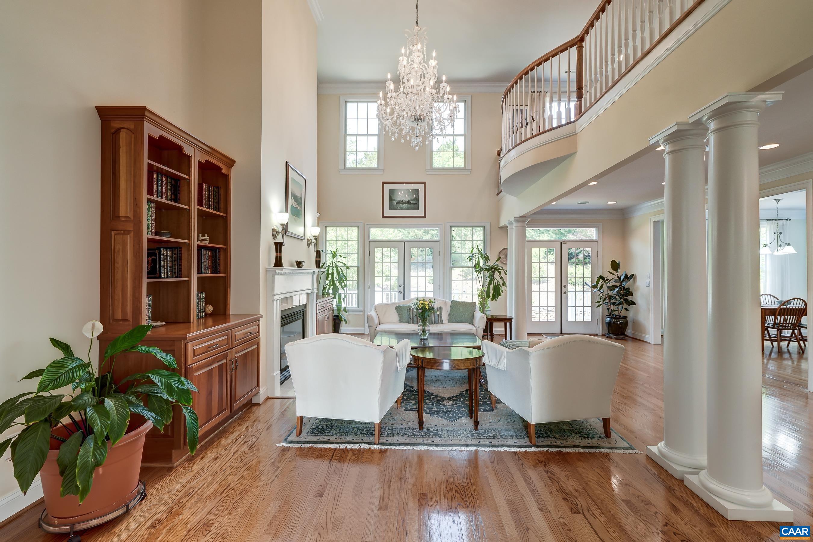 2-story great room features stunning crystal chandelier, gas fireplace and built-ins.
