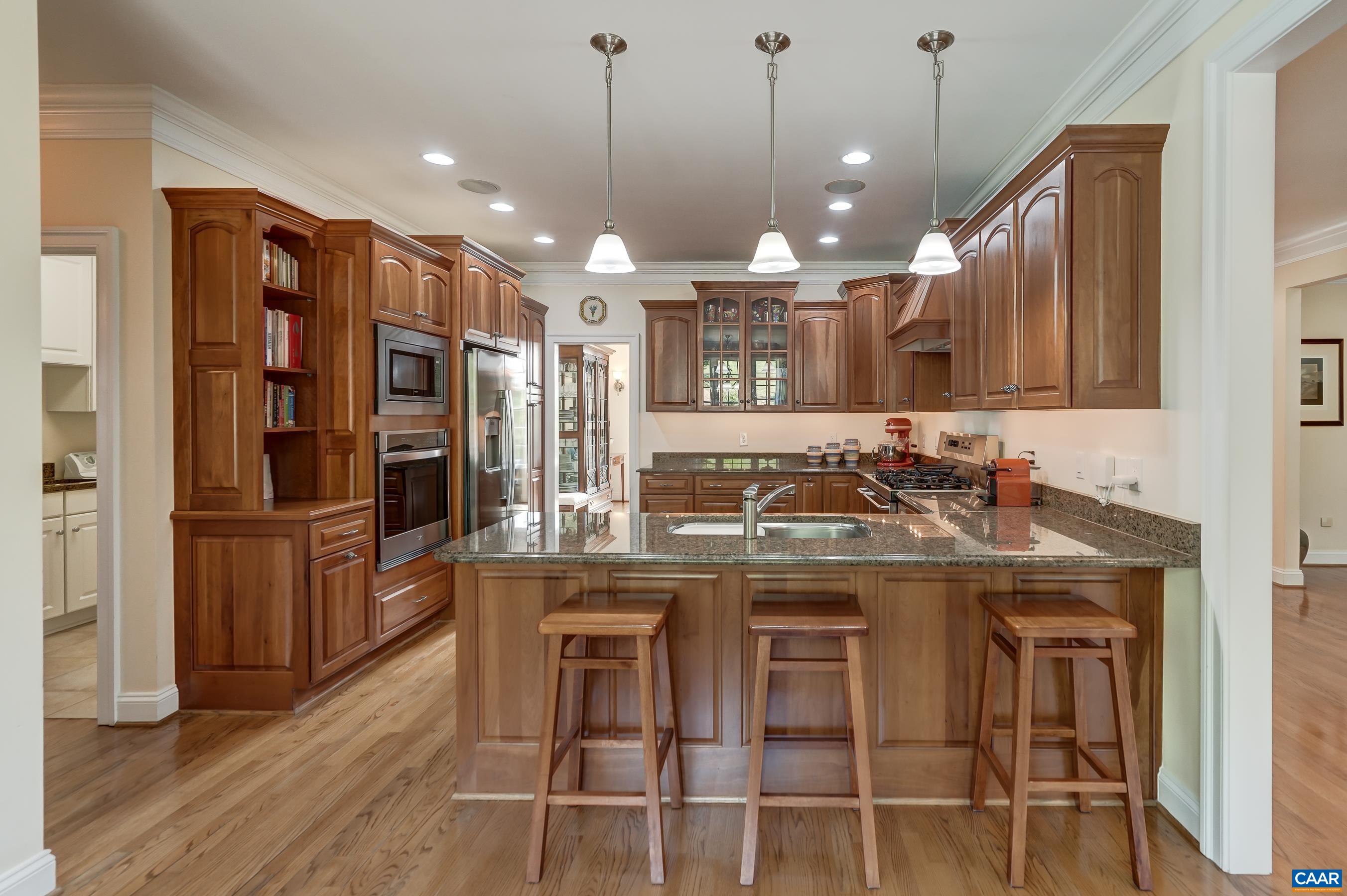 Chef-inspired kitchen features cherry cabinets and granite countertops.