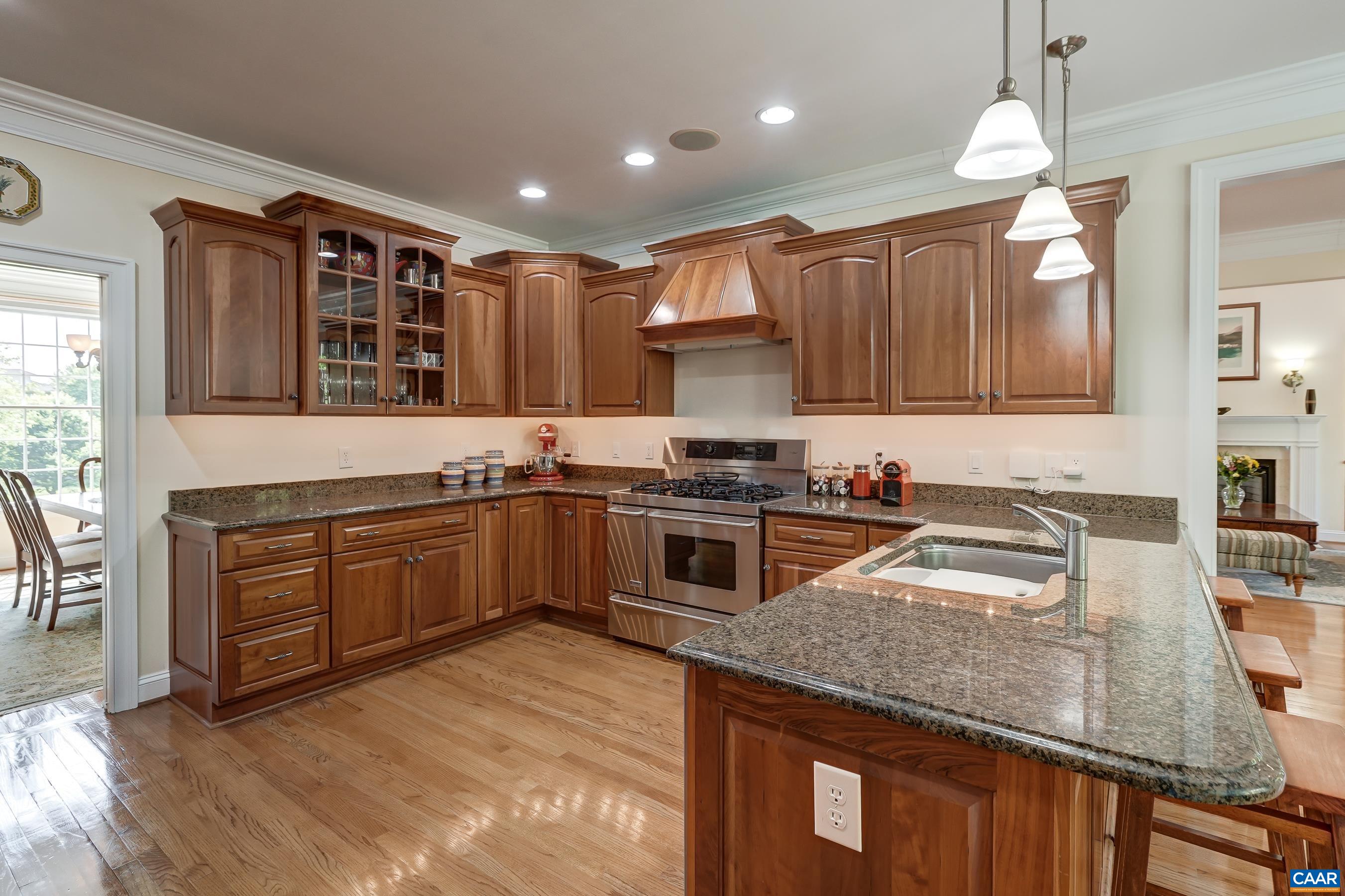 High-end stainless steel appliances include a 5 burner gas range.