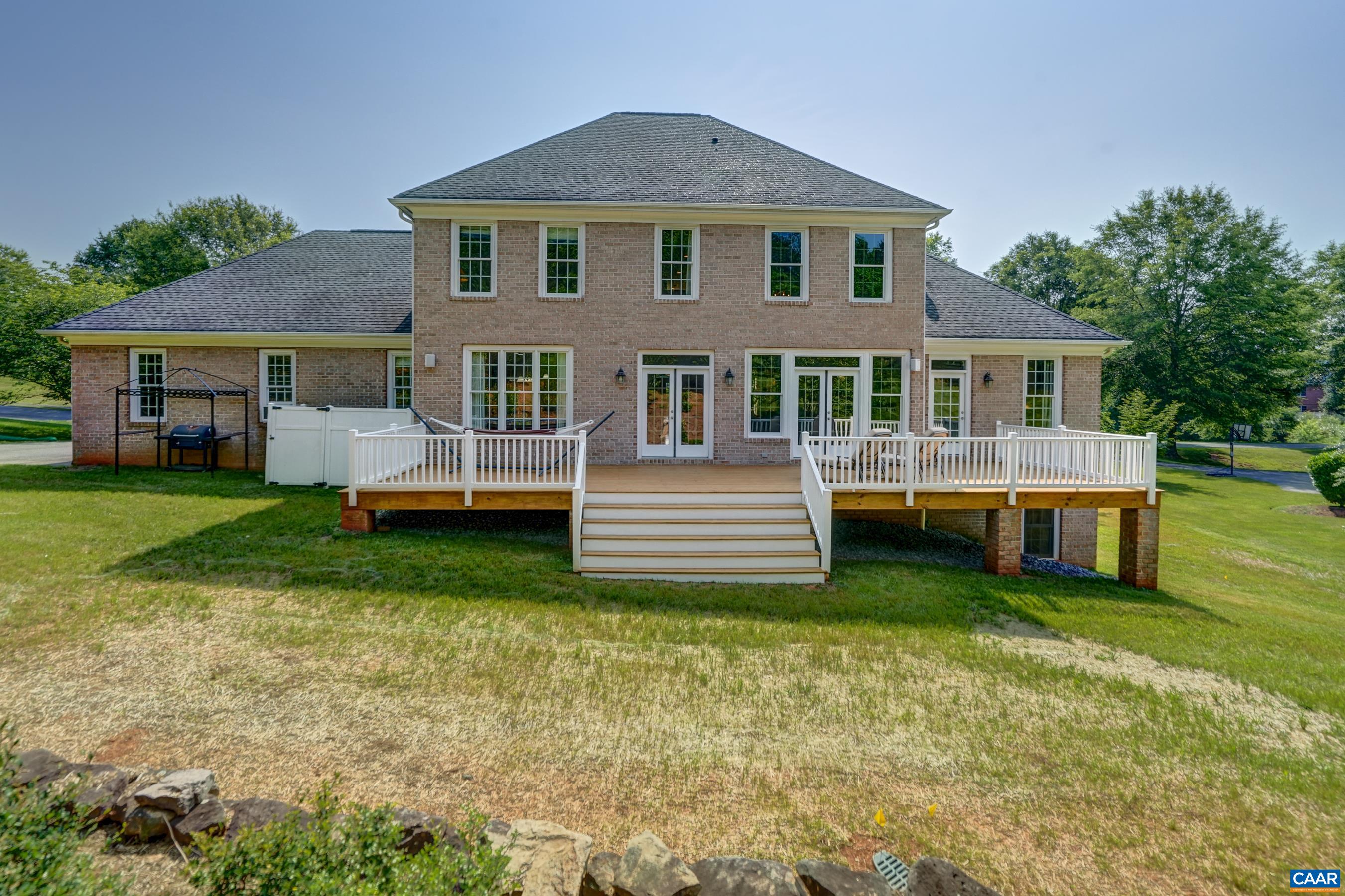 Beautifully landscaped yard and expansive deck. Owners have landscaping plans for Pool and more!