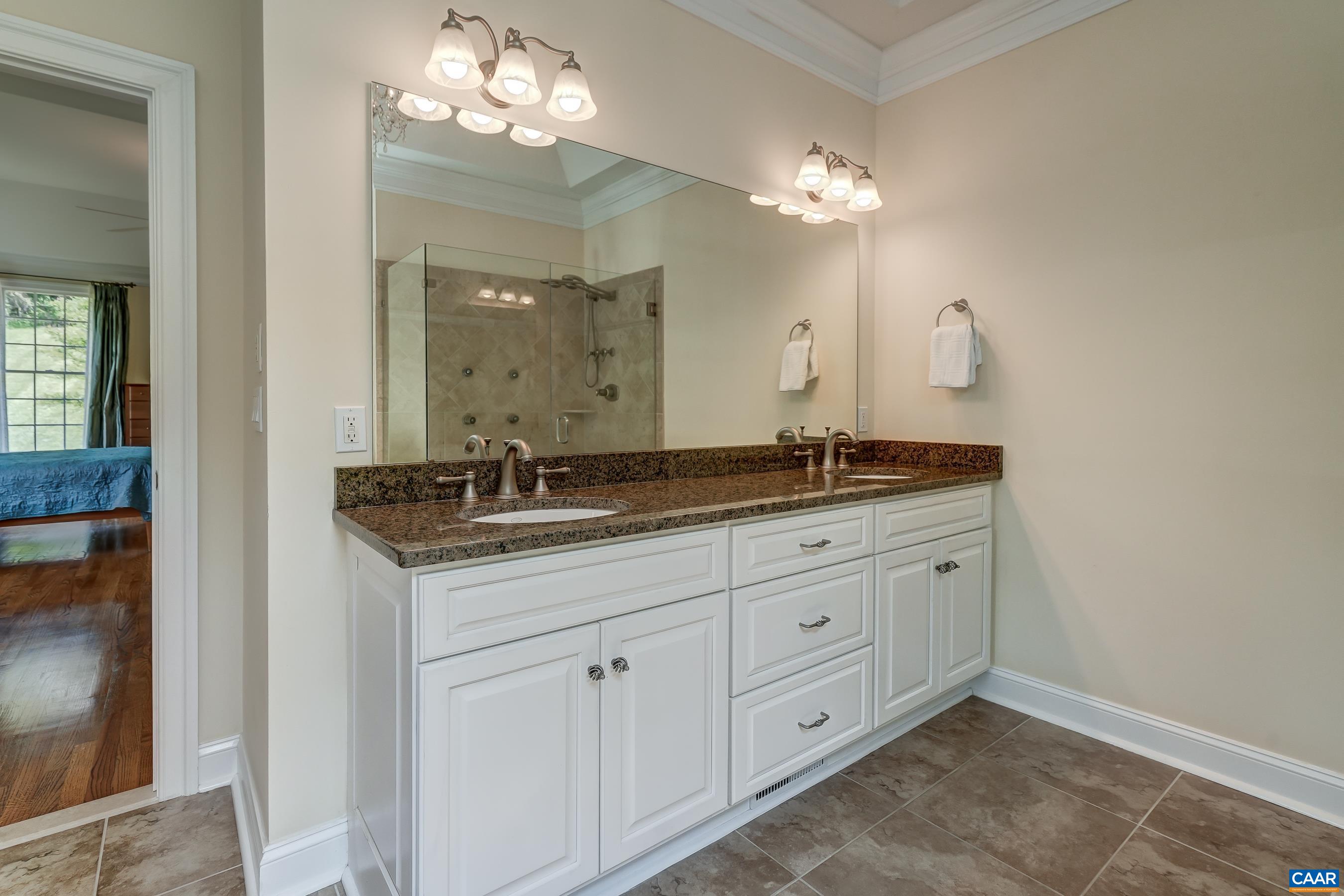 Primary bathroom with double sink vanity.
