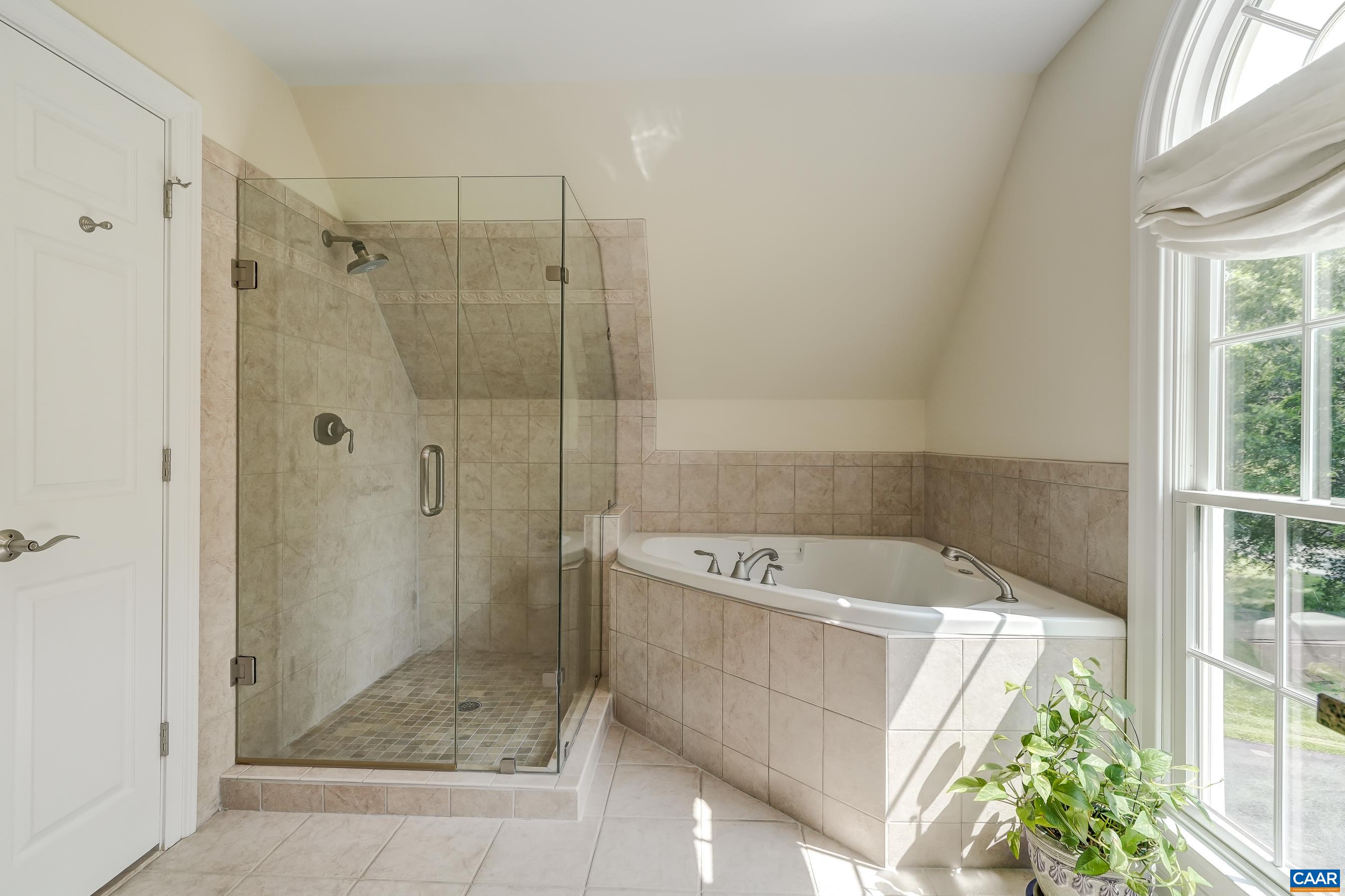 Separate shower and soaking tub in second level primary bath.