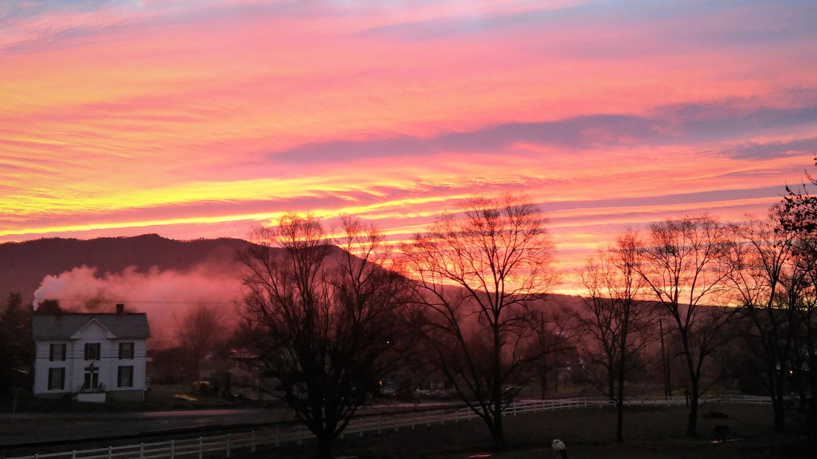 Eastern morning sunrise over the Massanutten Peak mountain range. Picture taken from front porch.