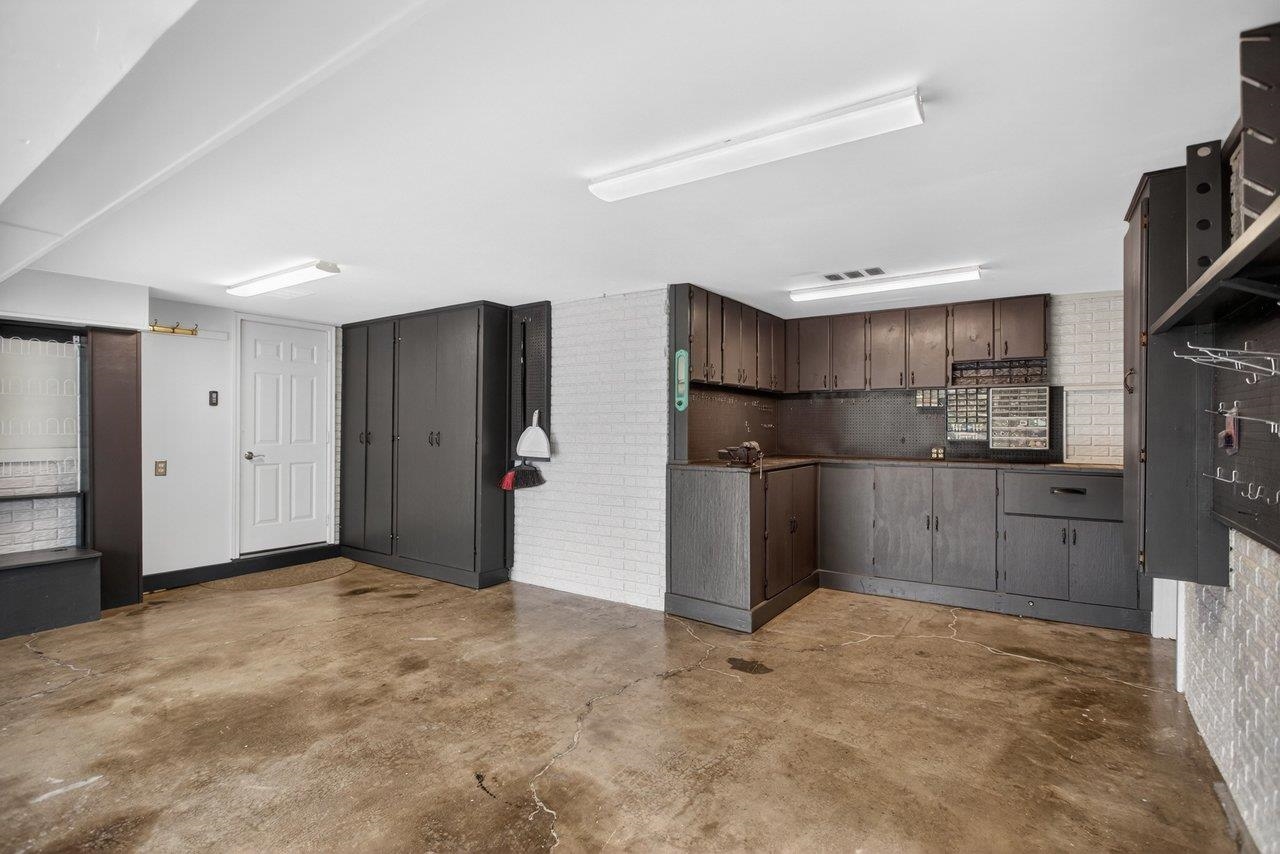 2 car garage with workshop and custom built-ins.