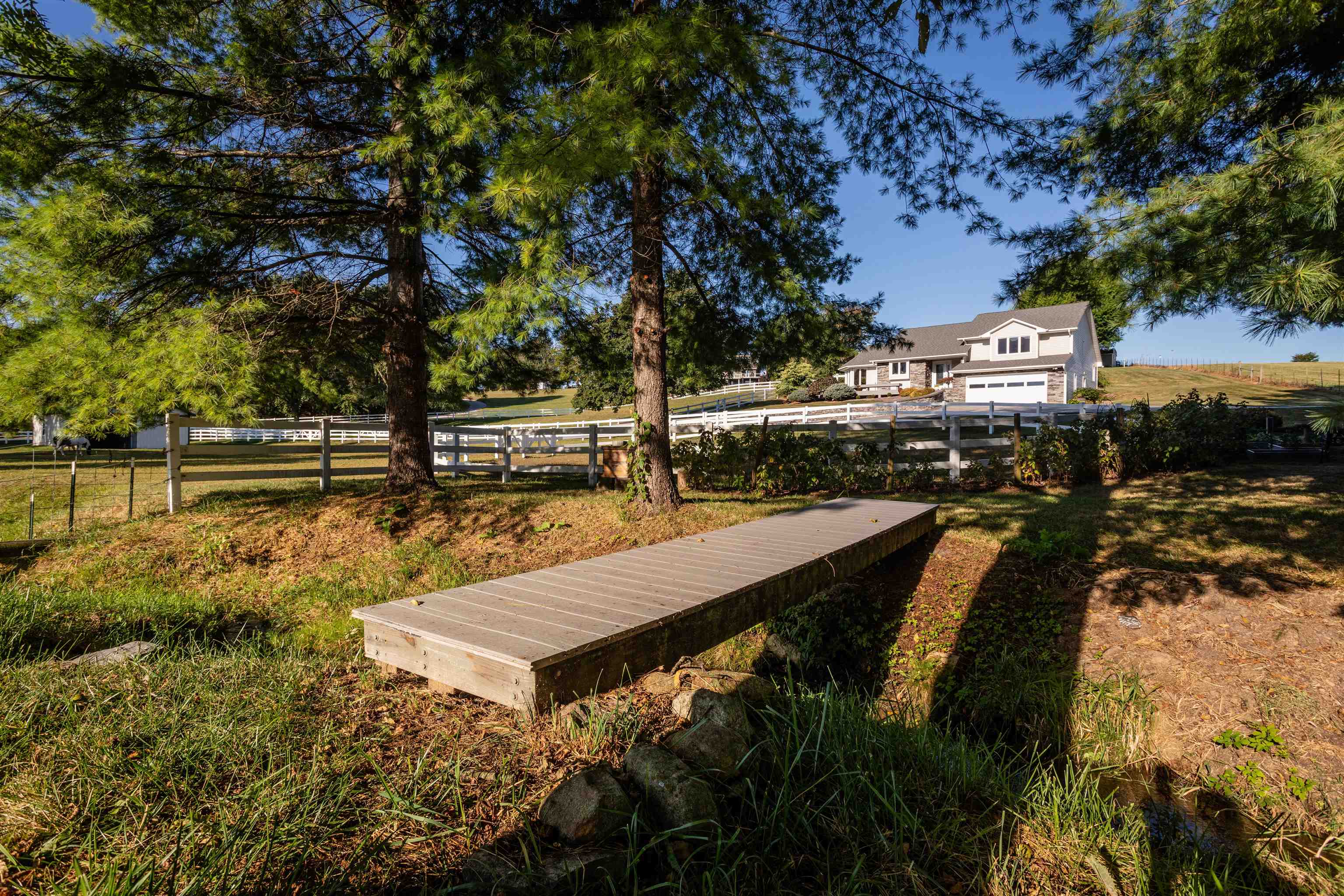 Composite decking walking bridge across stream.