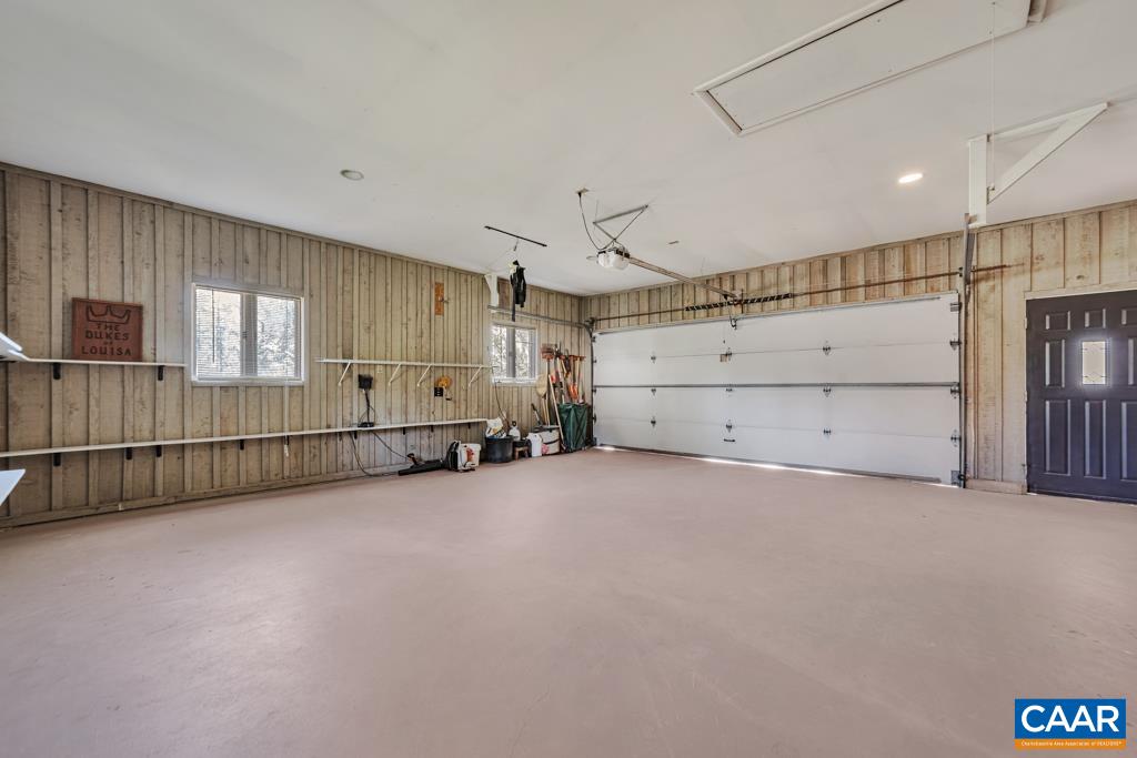 2 Car Garage with shelving, closet and still plenty of trash can storage.