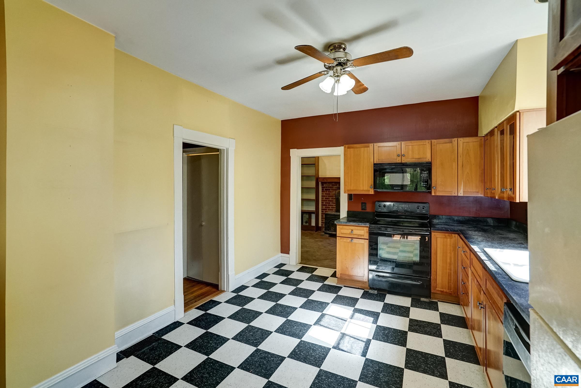 Updated kitchen with soapstone counters and shaker style cabinets.