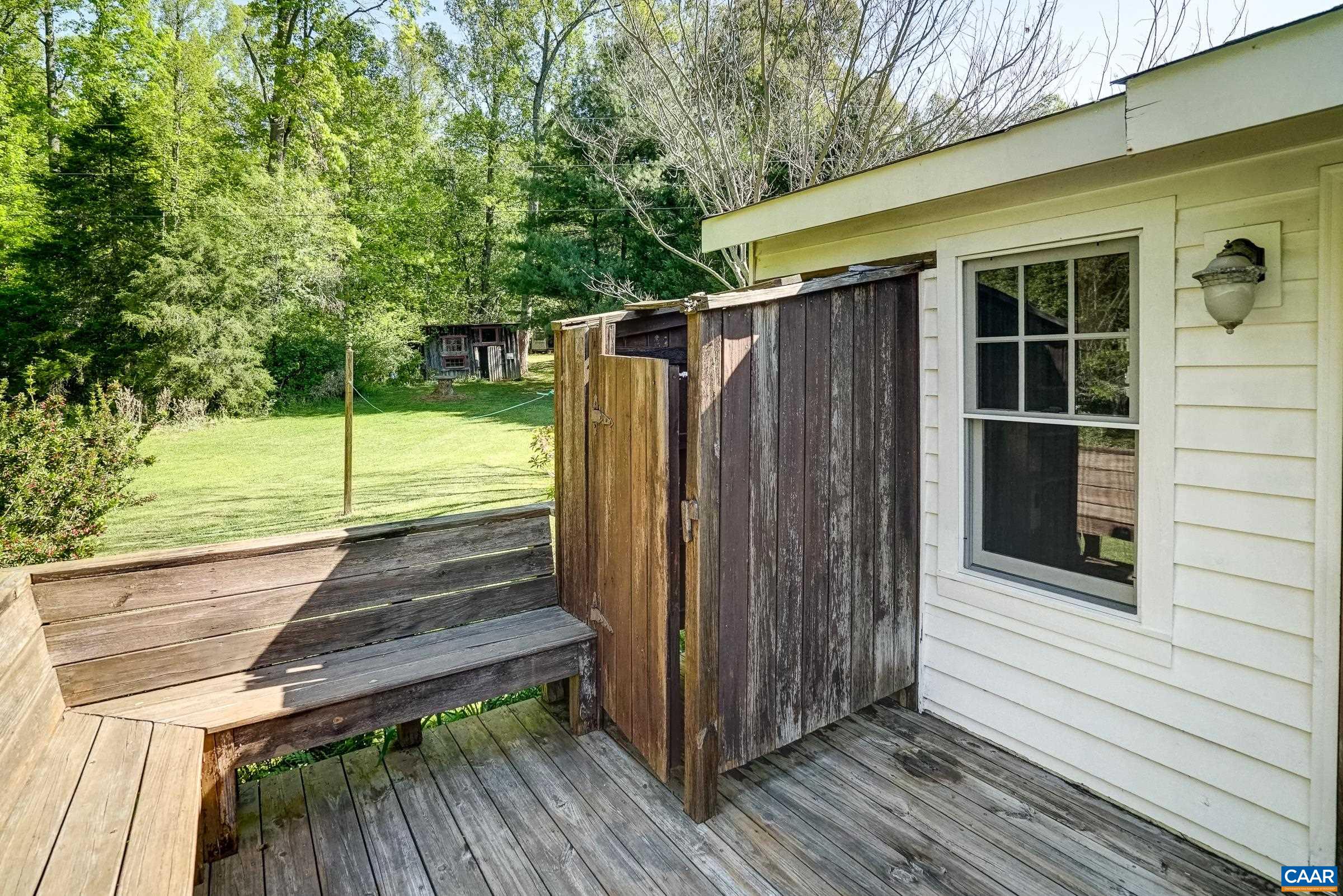 Deck with bench seating and outdoor shower!