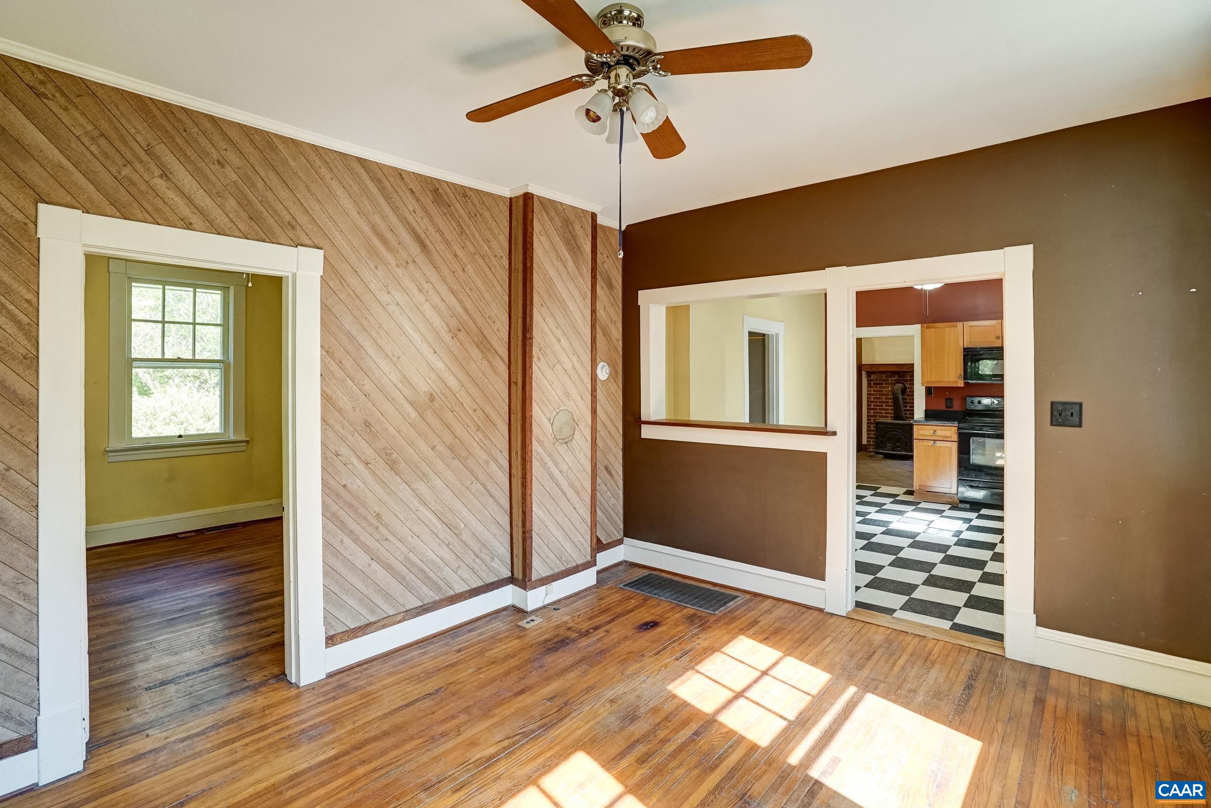 Original hardwood floors in the light-filled living room.