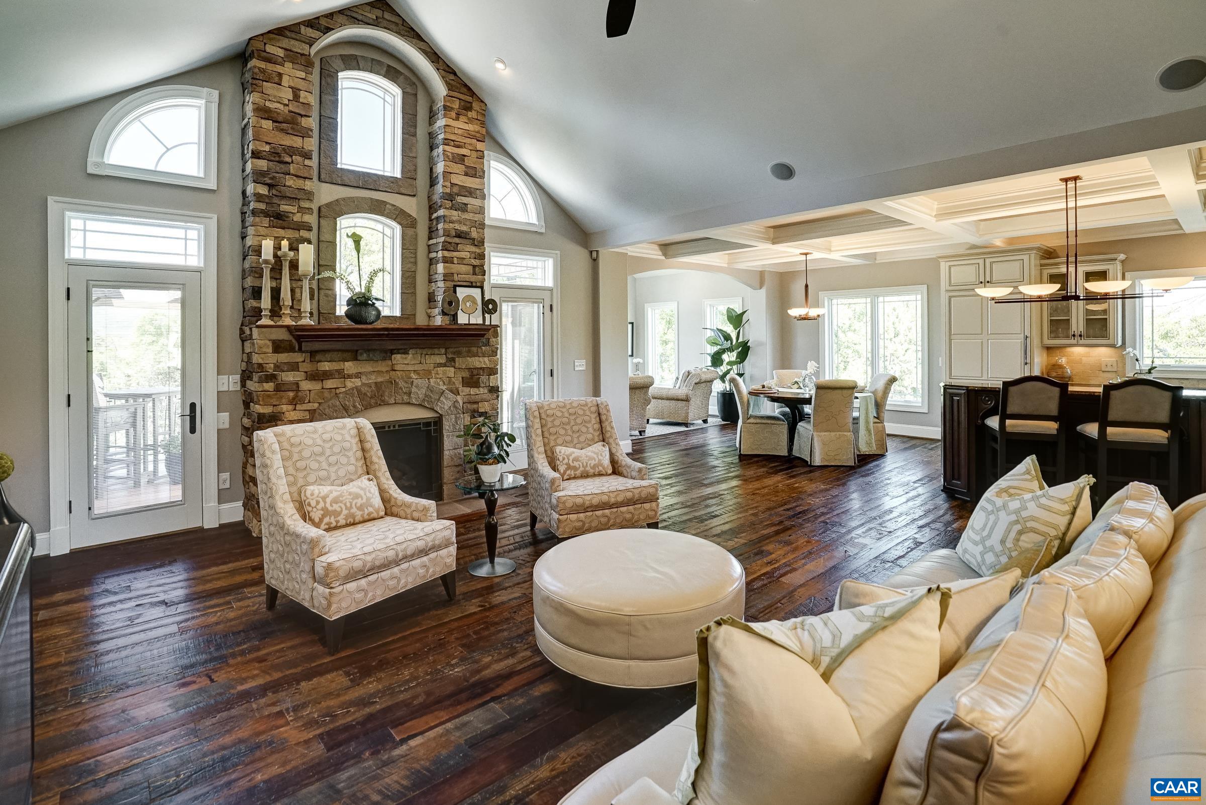 Vaulted great room with stacked stone gas fireplace is a  stunner!