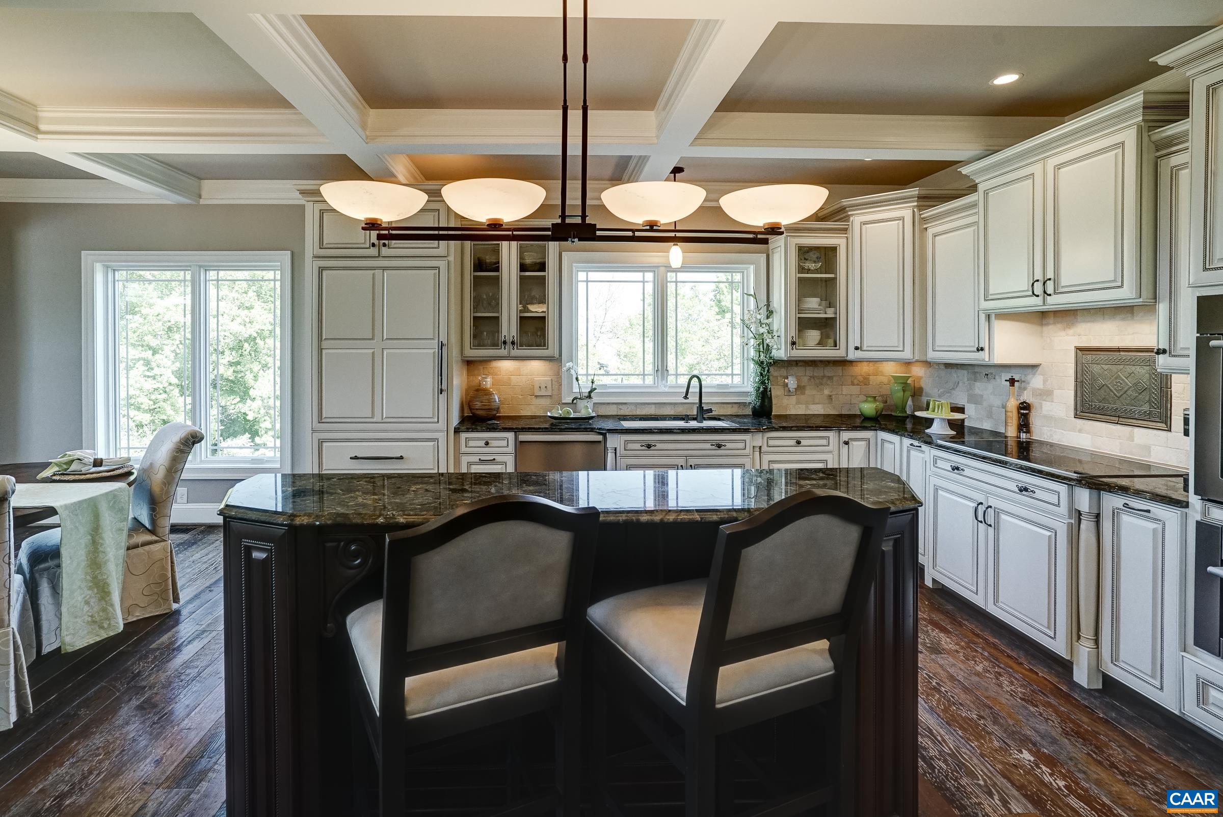 High-end Miele appliances include a paneled refrigerator, induction range and wall oven.