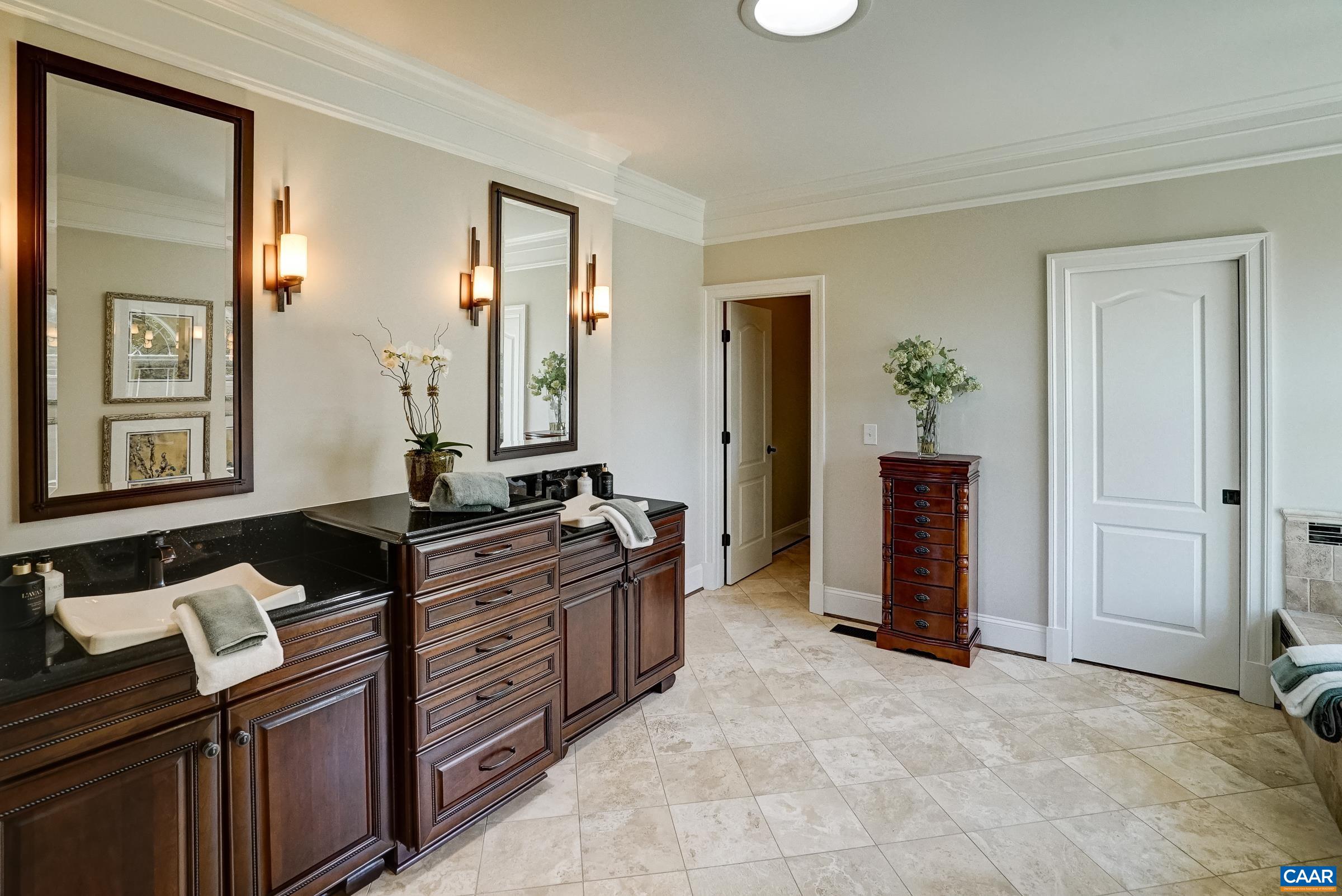 Spa-like primary ensuite bathroom features double sink vanity.