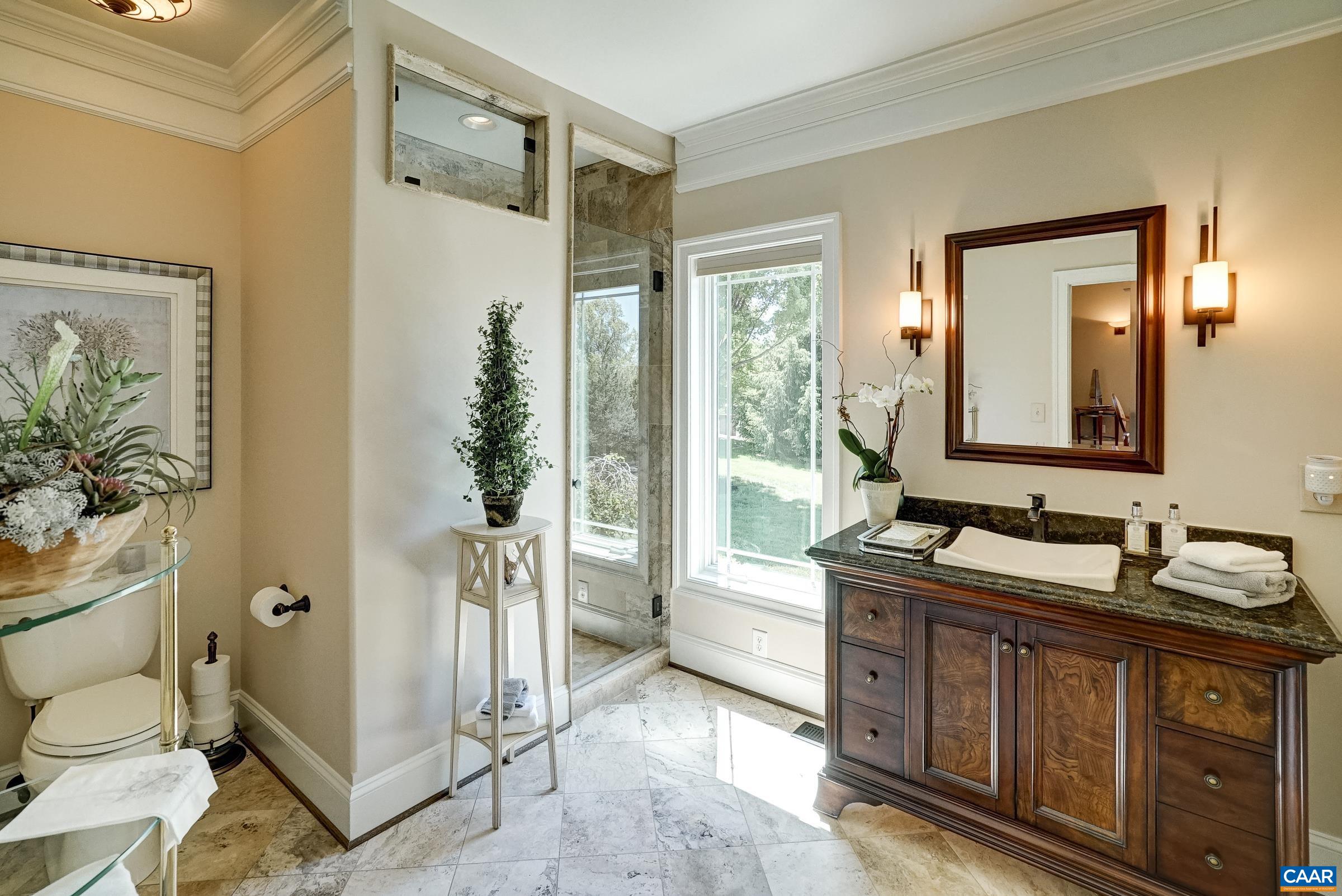 Beautiful full bathroom with frameless glass tiled shower.