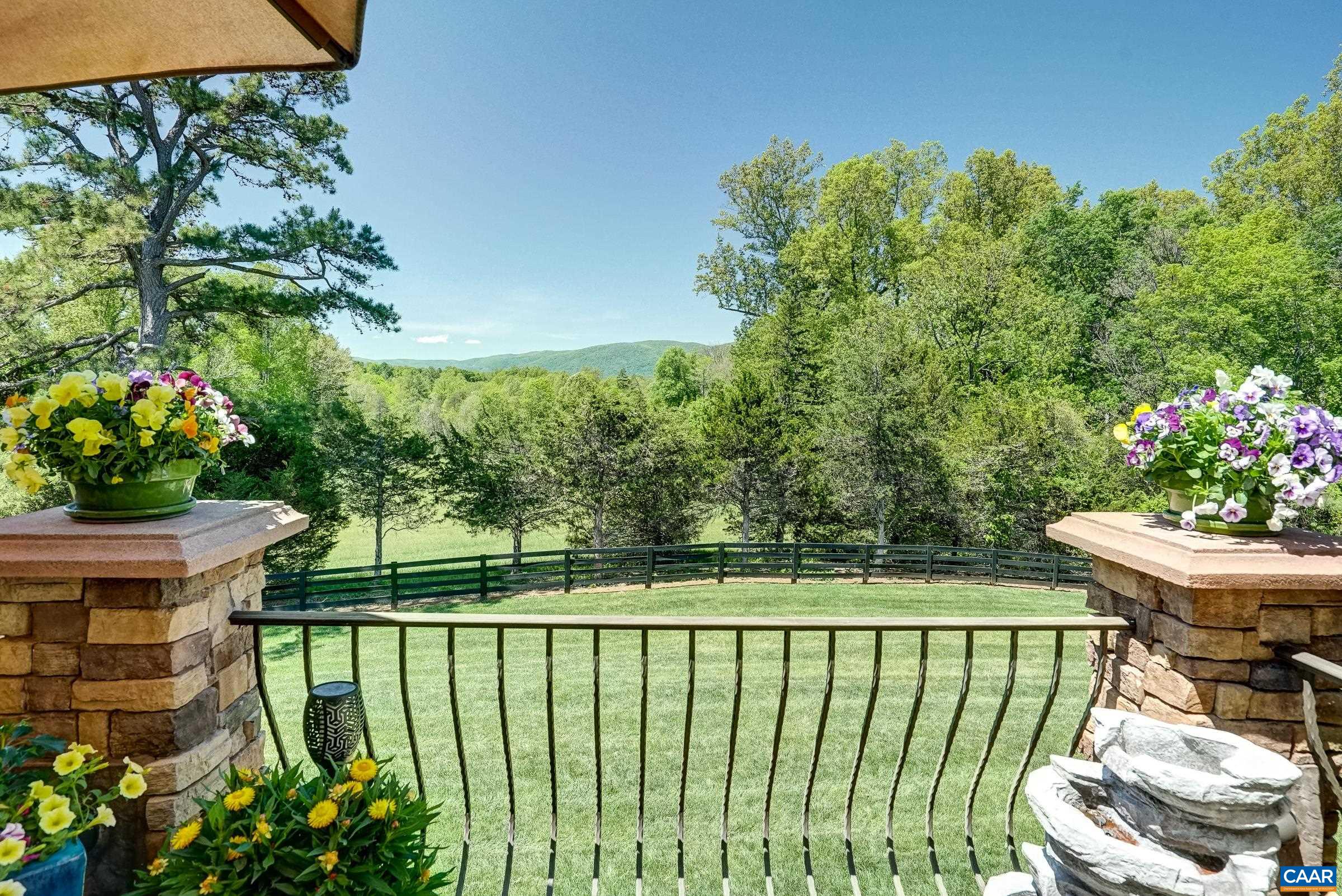 Composite decking stone pilars and wrought iron rails.