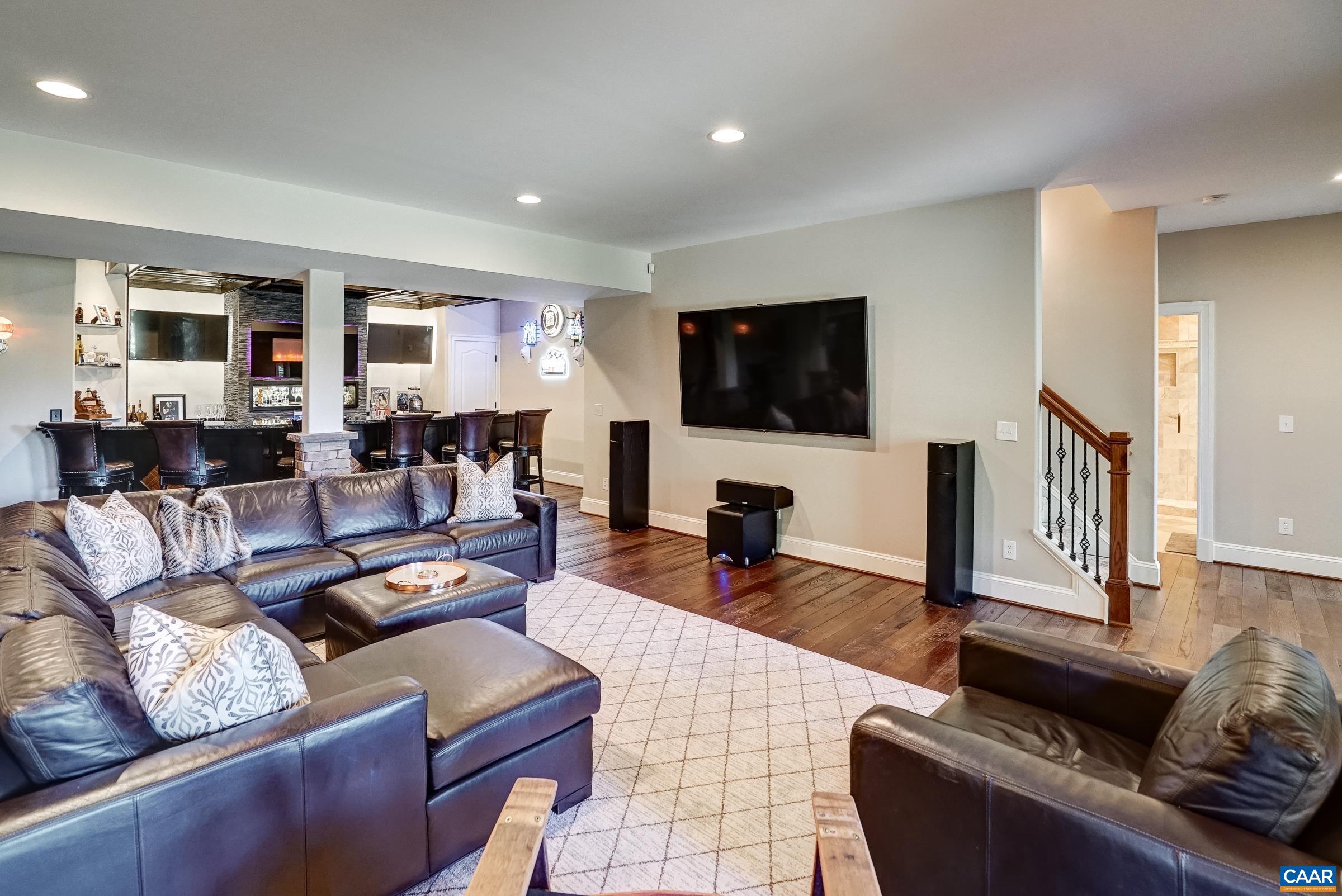 Dark hardwood floors in this stunning rec room - Imagine a game night in this basement!