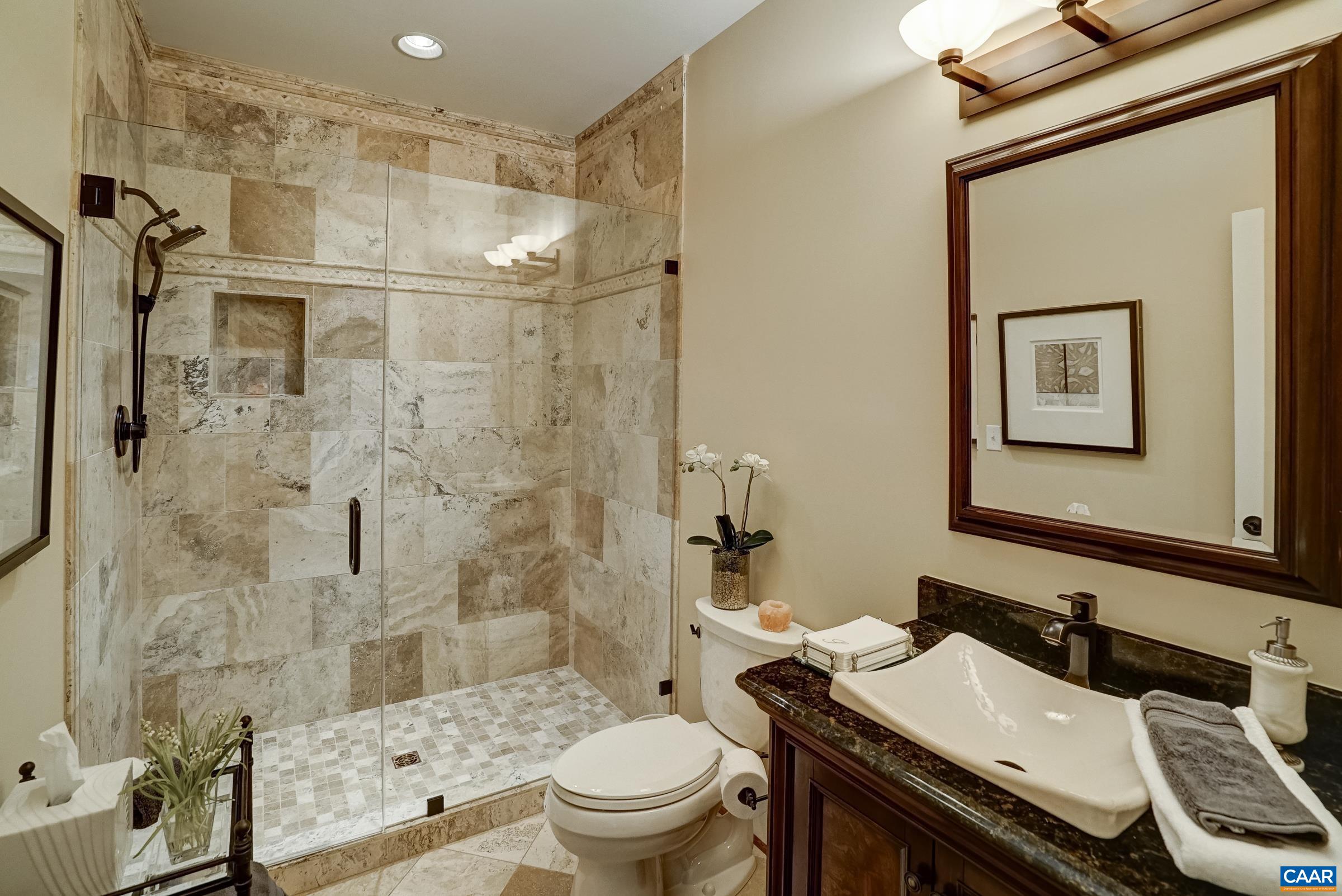 Full bathroom with travertine tile and frameless glass shower!