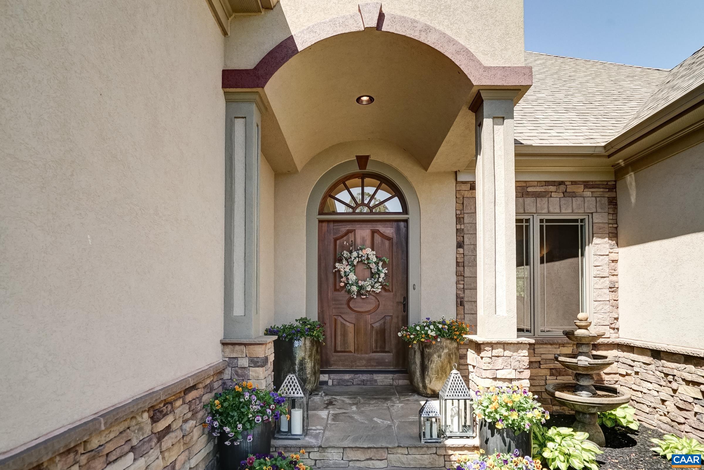 Covered front porch and mahogany solid wood door welcome guests.