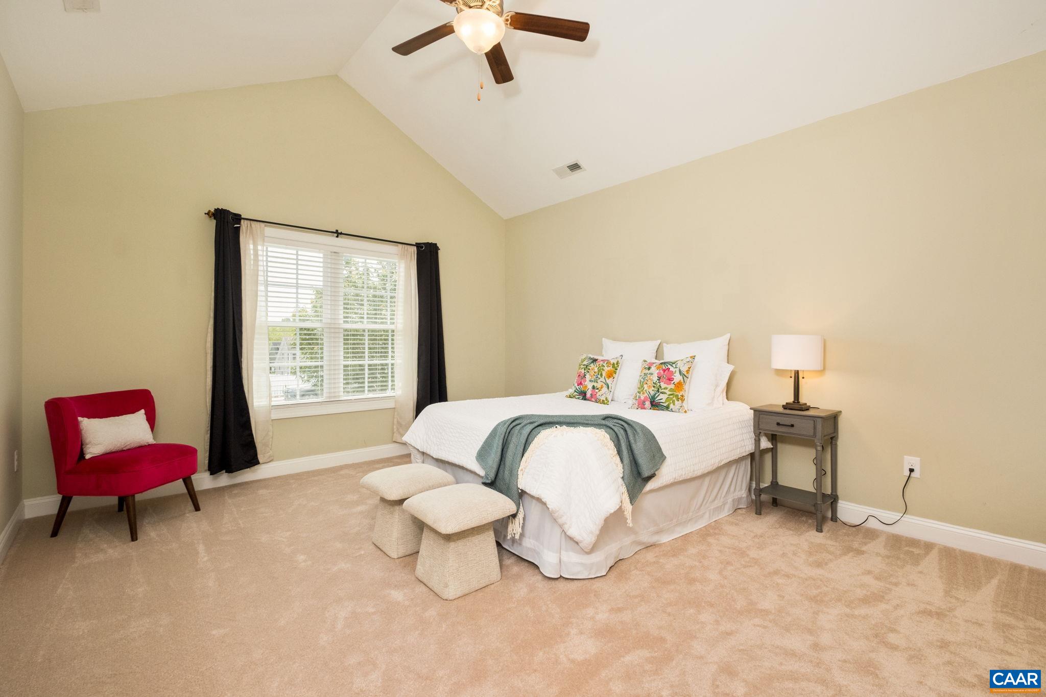 Primary suite features ceiling fan and ensuite bathroom.