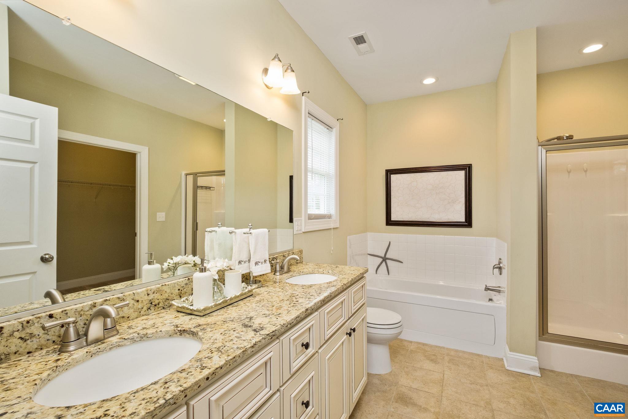 Primary bathroom with double sink vanity, jetted tub, and separate shower!