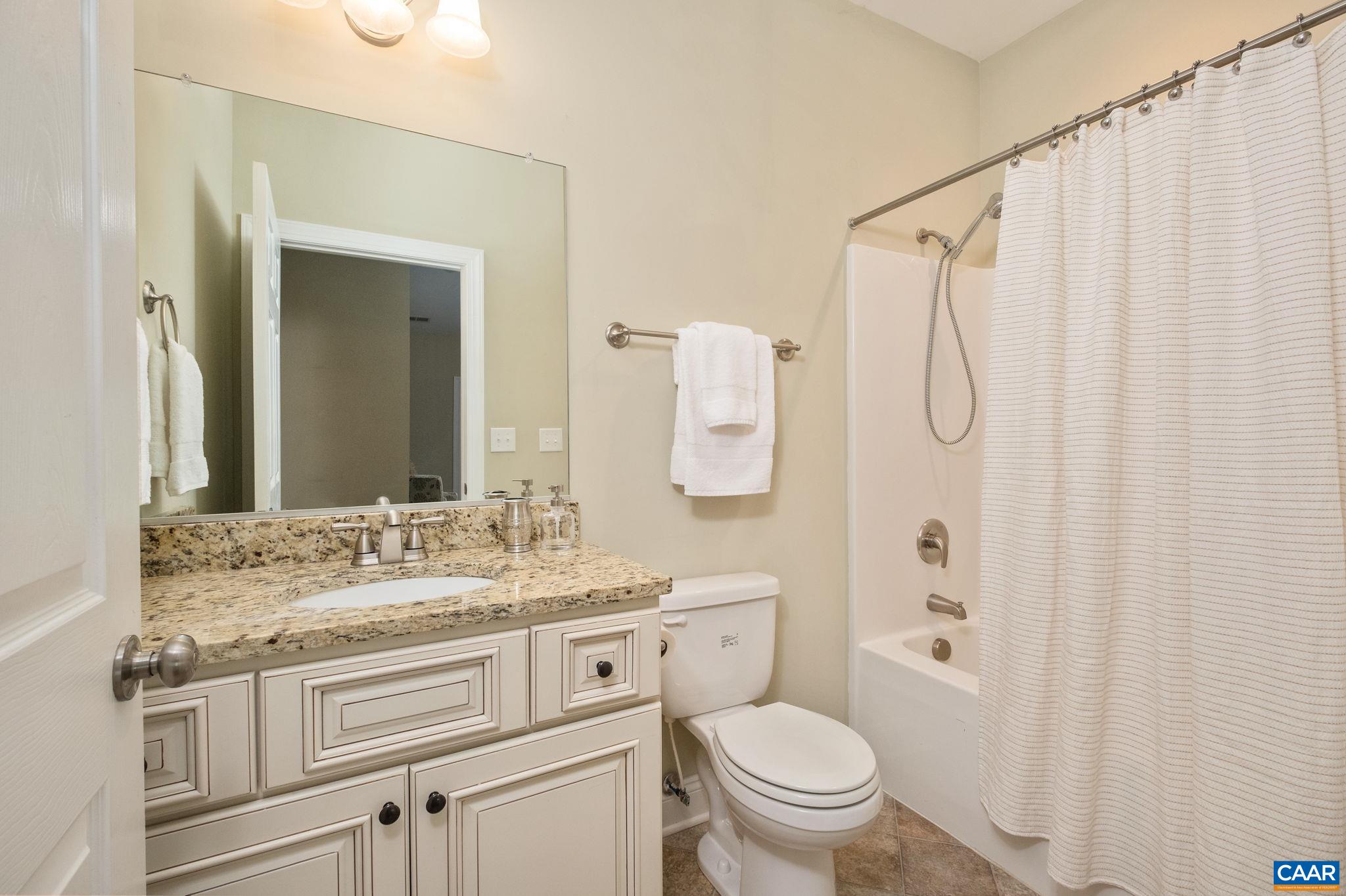 Full bathroom with tub/shower combo.