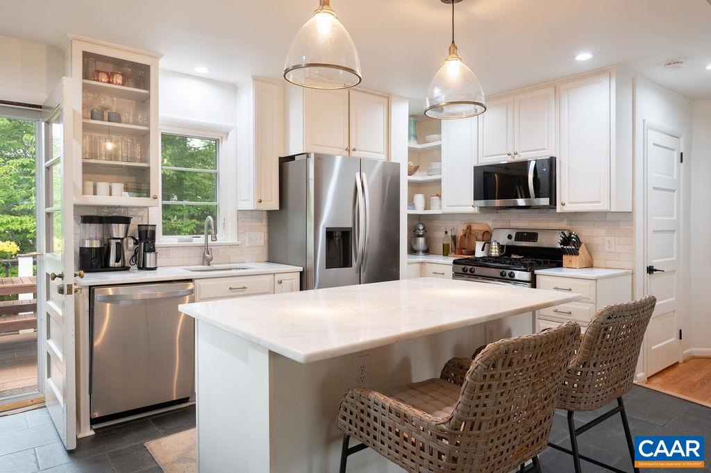 Gorgeous stone countertops and timeless finishes blending the vintage charm of the original build with modern updates