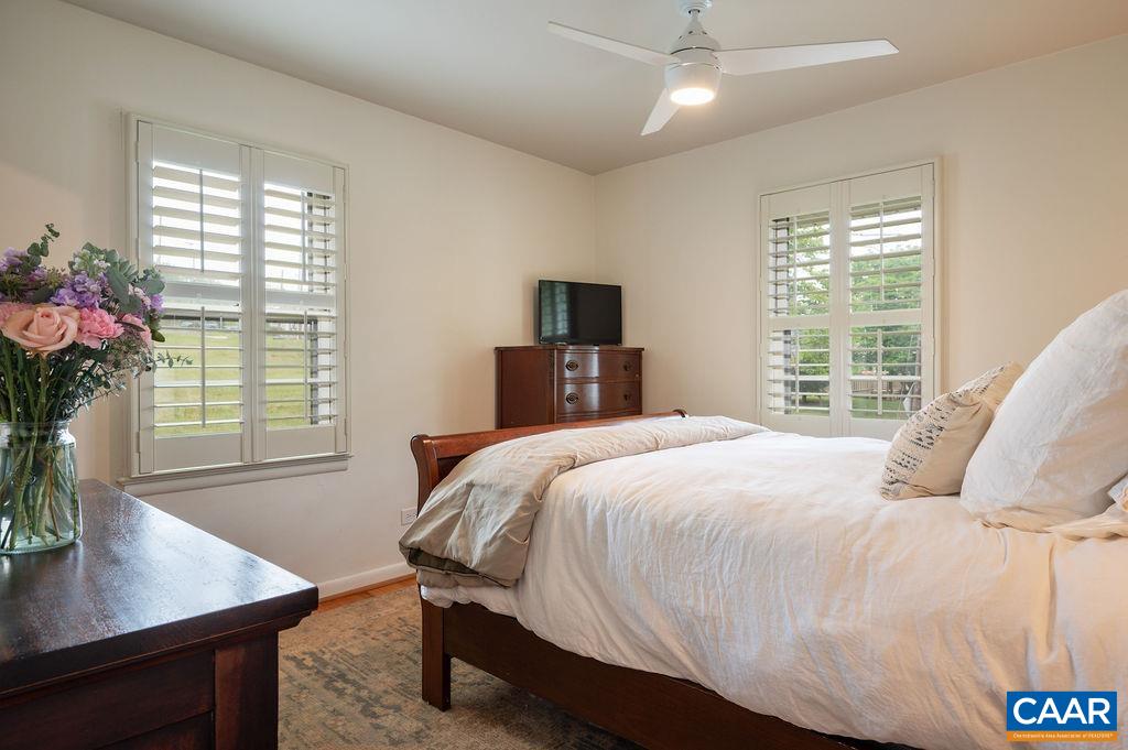 Primary suite features walk-in closet and tastefully updated bath