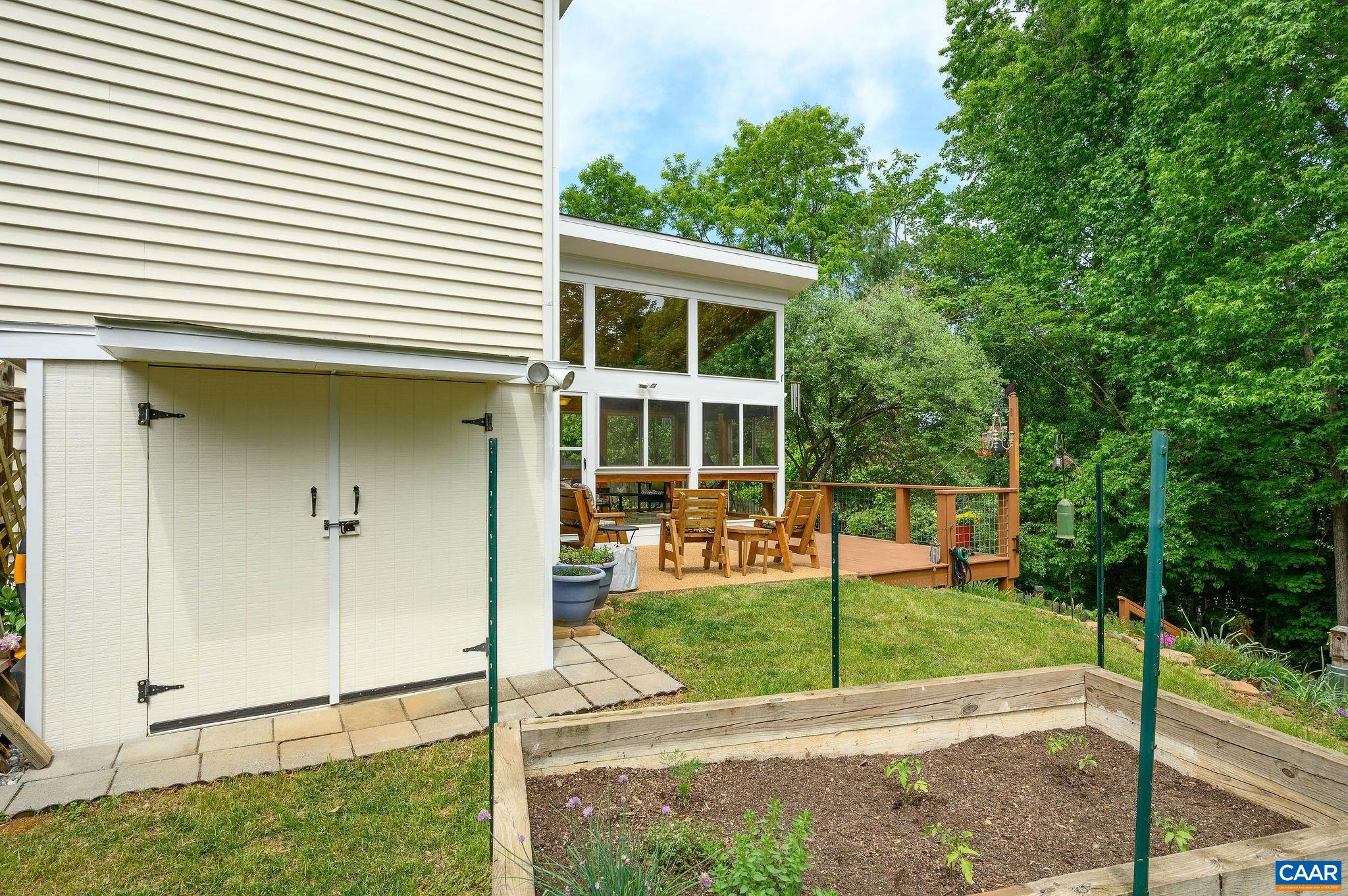 Outdoor custom built garden shed and planting beds.