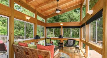 Custom vaulted screen porch with glass slides for all season enjoyment.