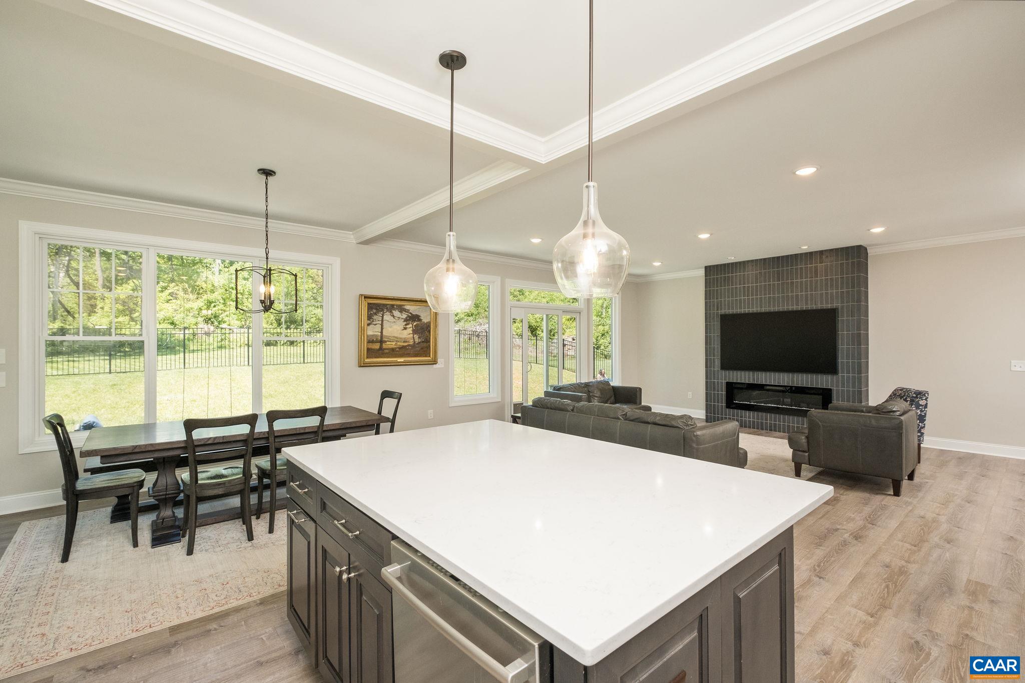 A featured highlight of the home is the coffered ceiling in the main living space.  View looks from the kitchen to the living room.