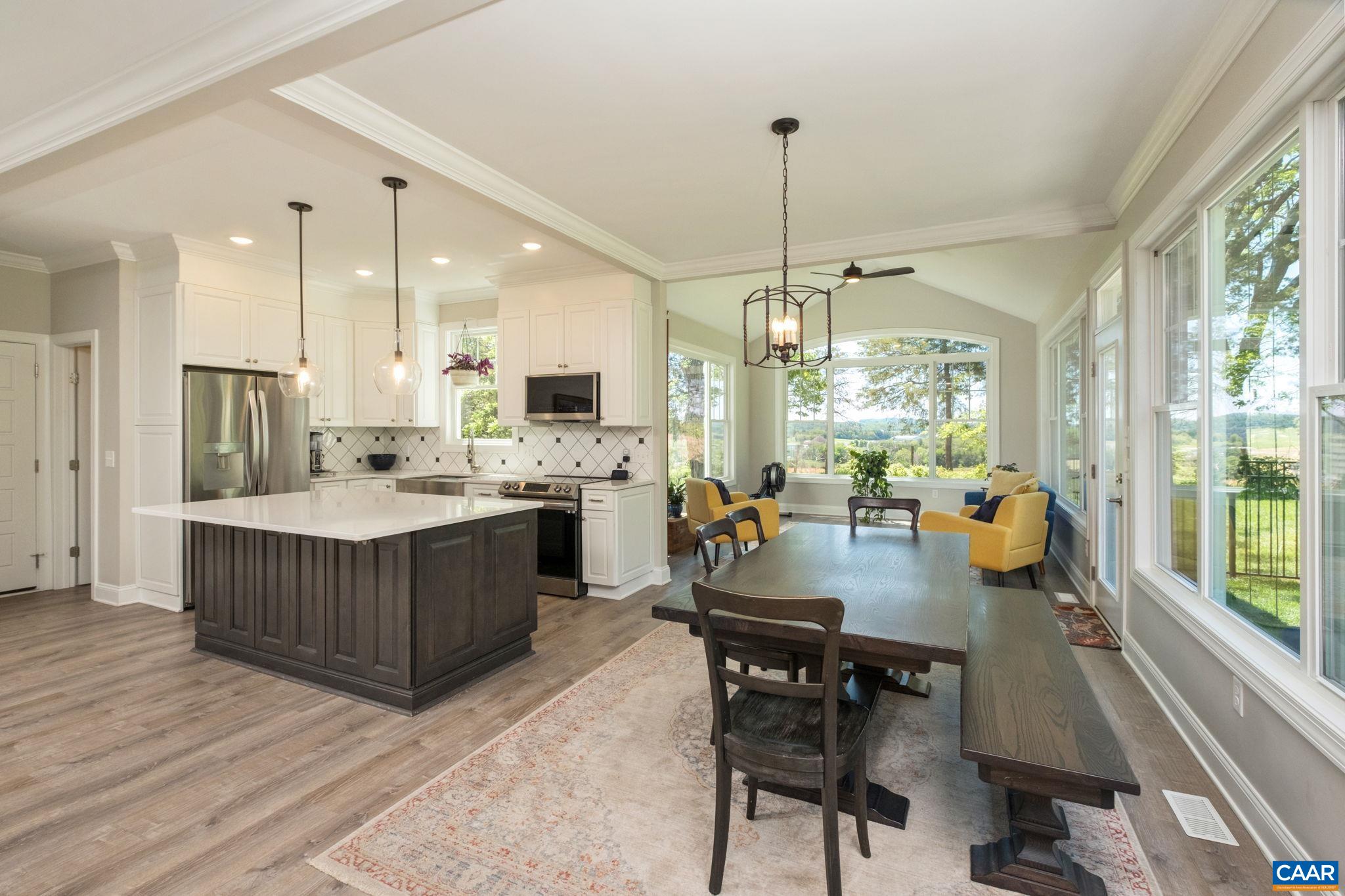 The walk-in pantry is to the left of the picture, behind the refrigerator.  The coffered ceiling is in view.  At nearly every place you stand in the main living space, you see picturesque views!