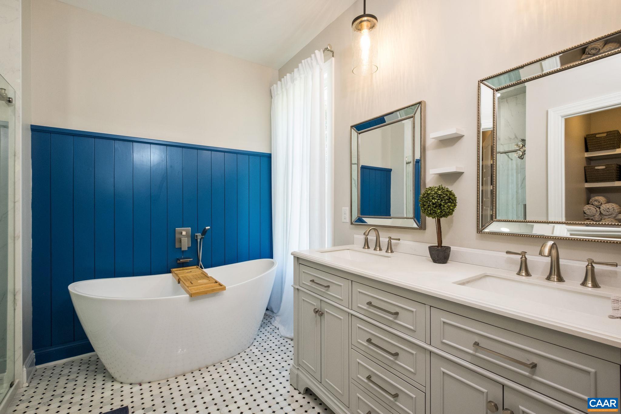 The primary bathroom features a garden tub and a tiled shower.