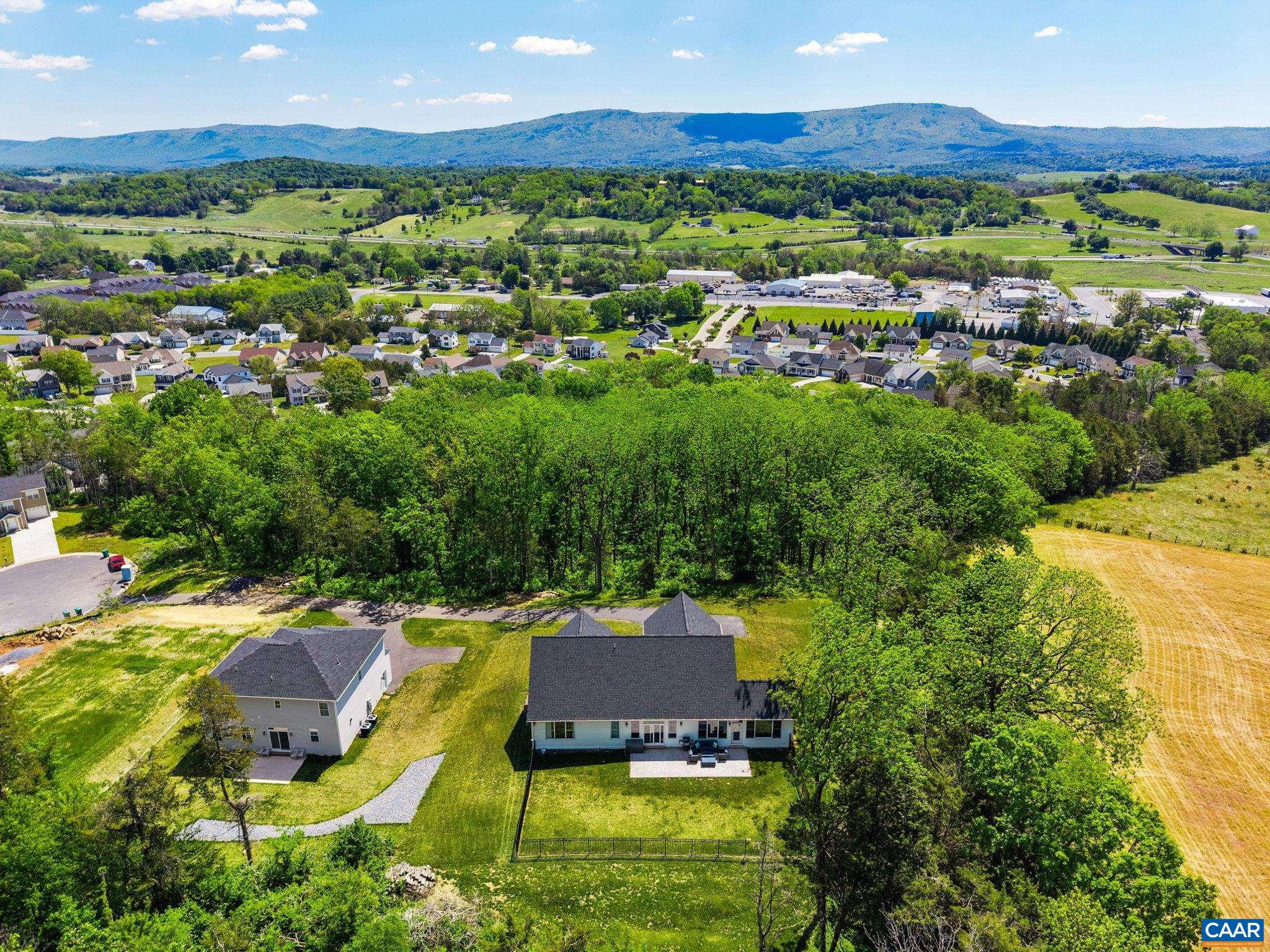 Mountain and panoramic pastoral views are visible from the home, both inside and outside.