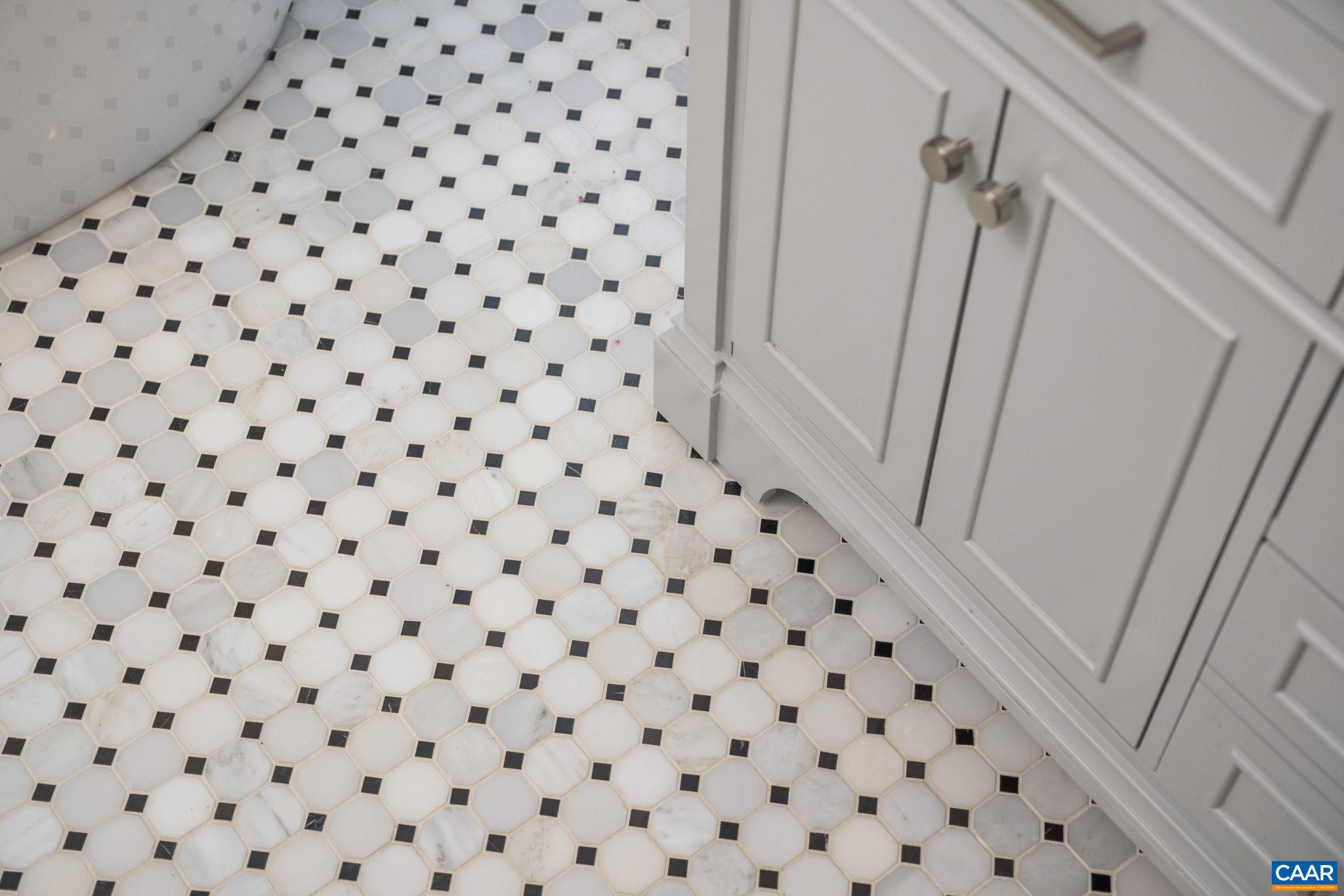 The tile flooring is a beautiful and subtle pattern that brings the primary bathroom together.