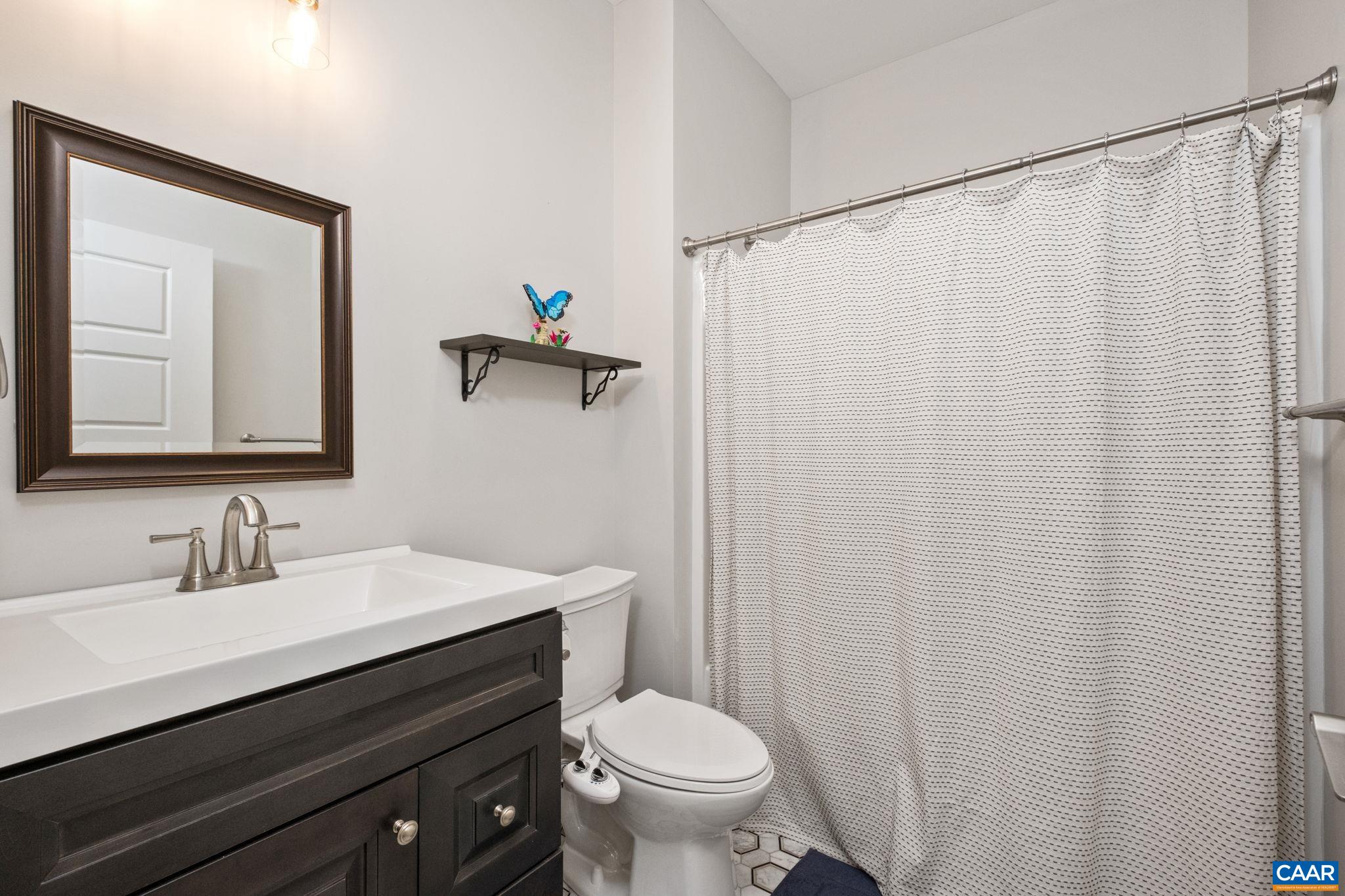 This full bathroom is located on the main level, in the hallway.