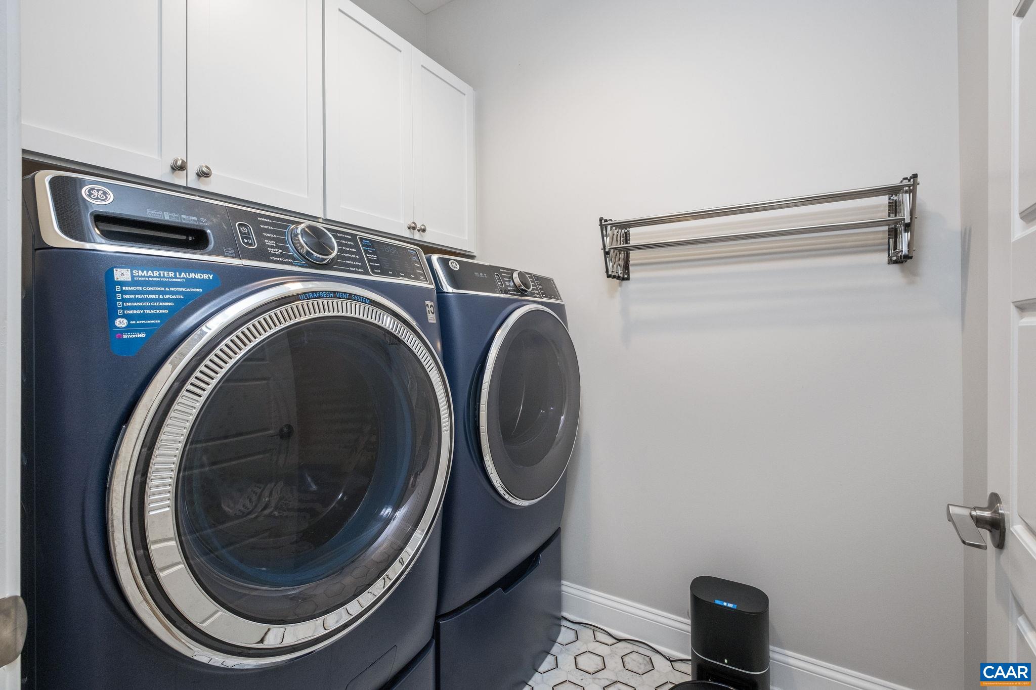 The laundry room is located on the main level, and features a drying rack.