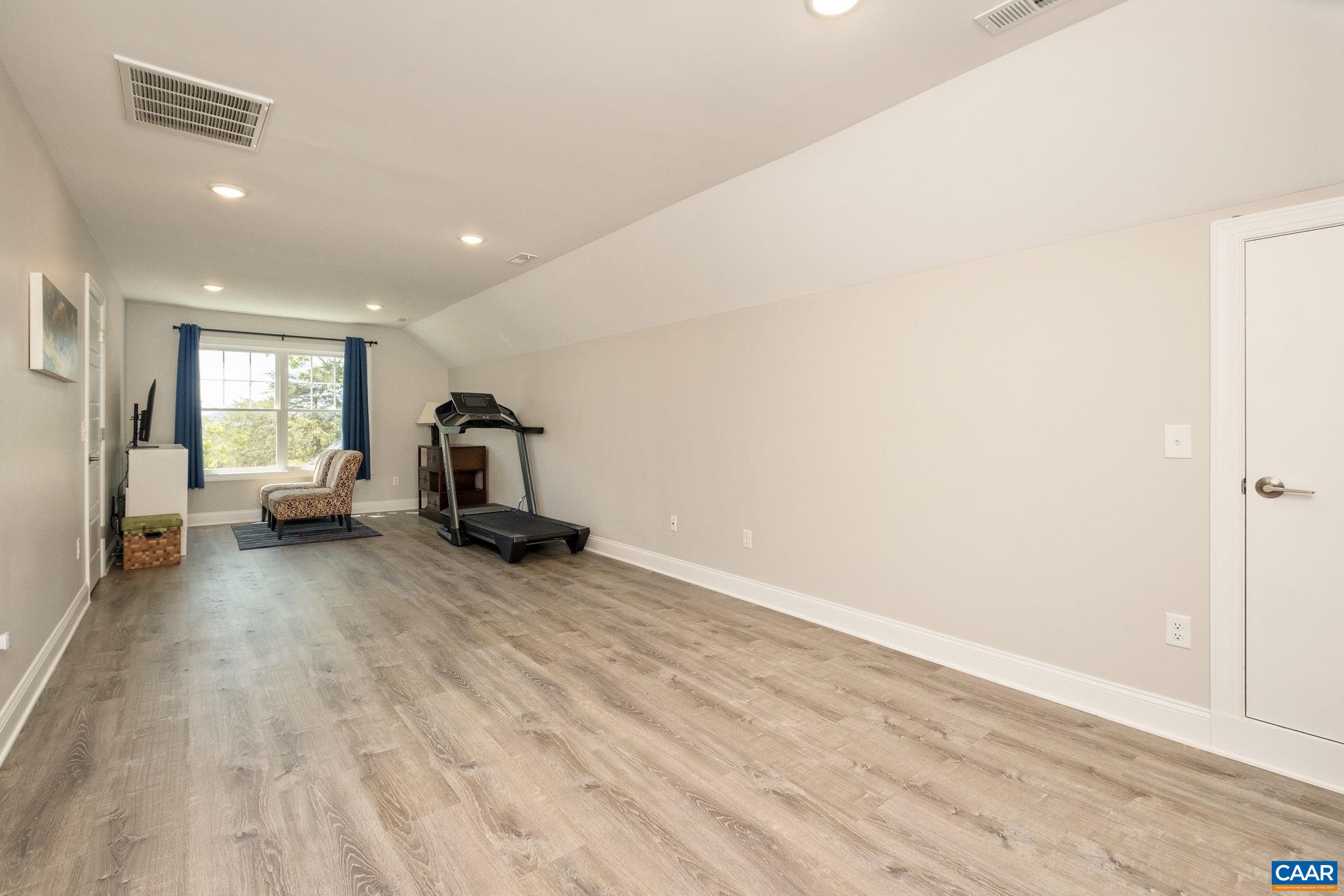 This large bonus room is located at the top of the stairs, and features storage areas.  This room is great for an art room, a gaming room, a home office, and more!